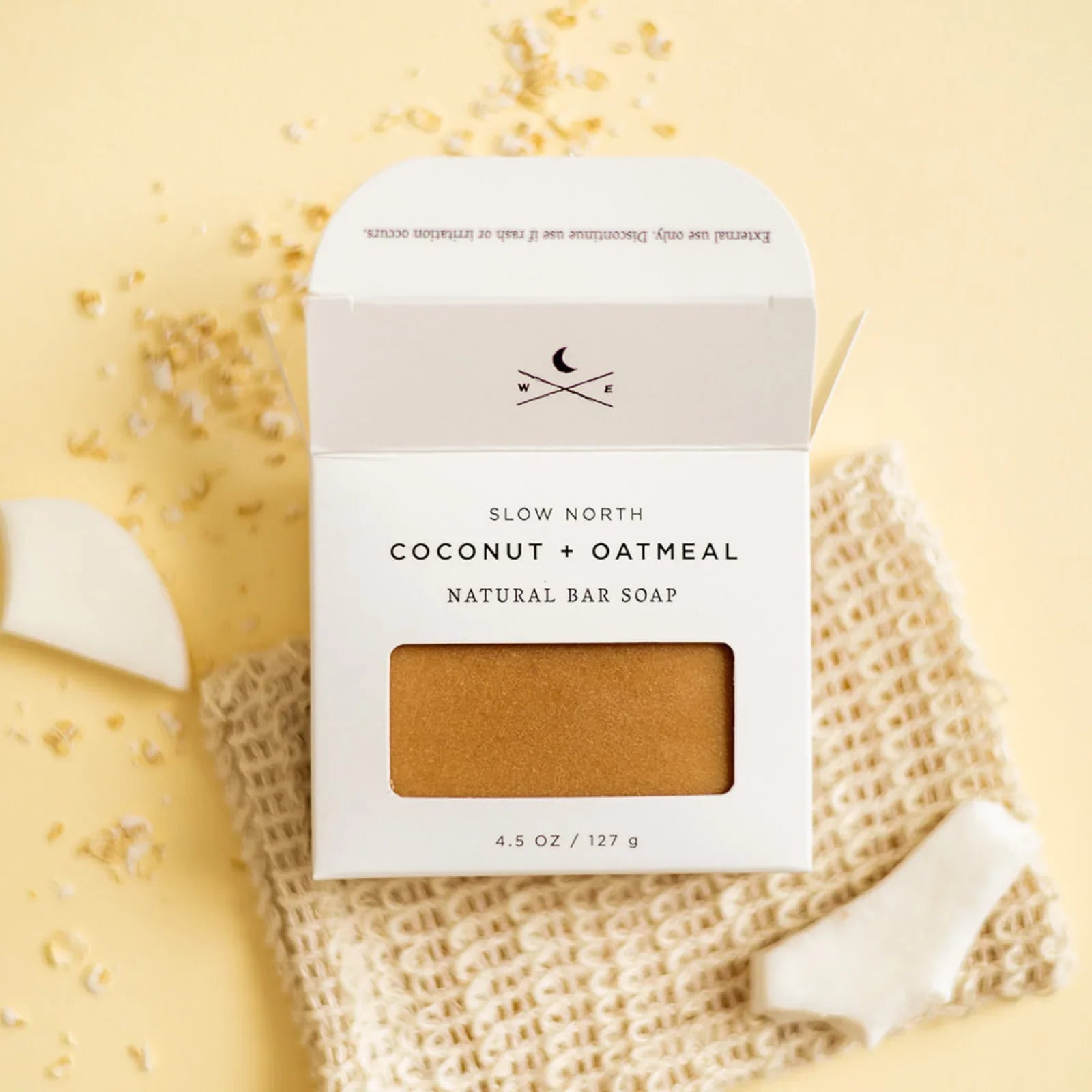 Slow North Coconut + Oatmeal natural bar soap in white box with soap bar visible on woven cloth