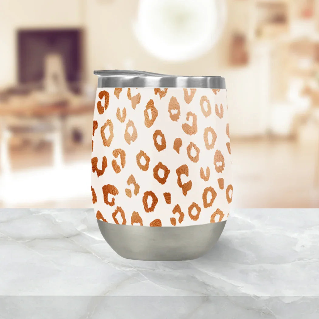Copper leopard print wine tumbler with stainless steel base on marble surface at Qu!rk Boutique