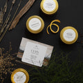 Hand-poured soy candles Cozy Collection by Slow North with dried botanicals flat lay.
