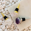 Crystal wine stoppers with gold and silver accents on white stones, Qu!rk Boutique gift