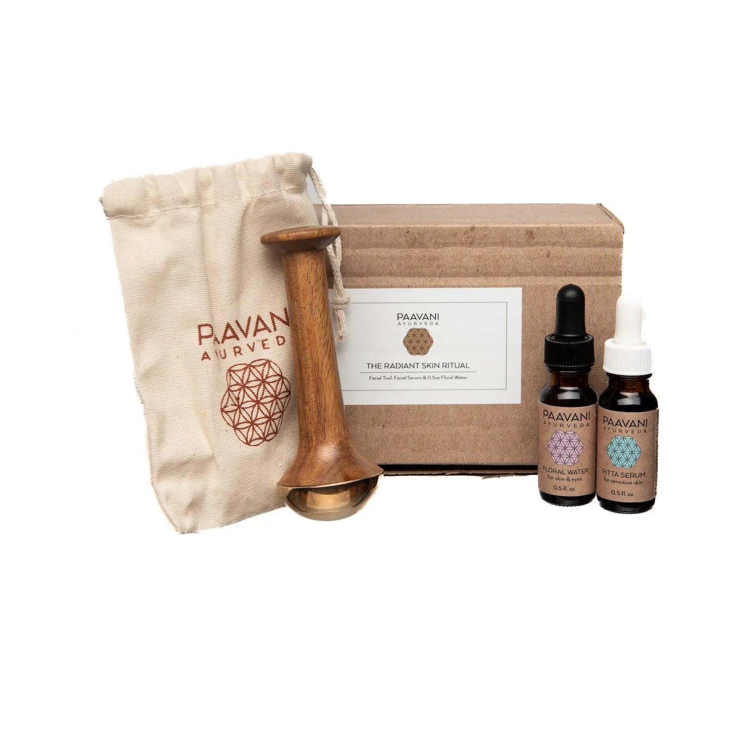 Paavani Ayurveda Radiant Skin Ritual kit with serum bottles, wooden tool, and gift pouch at Qu!rk Boutique