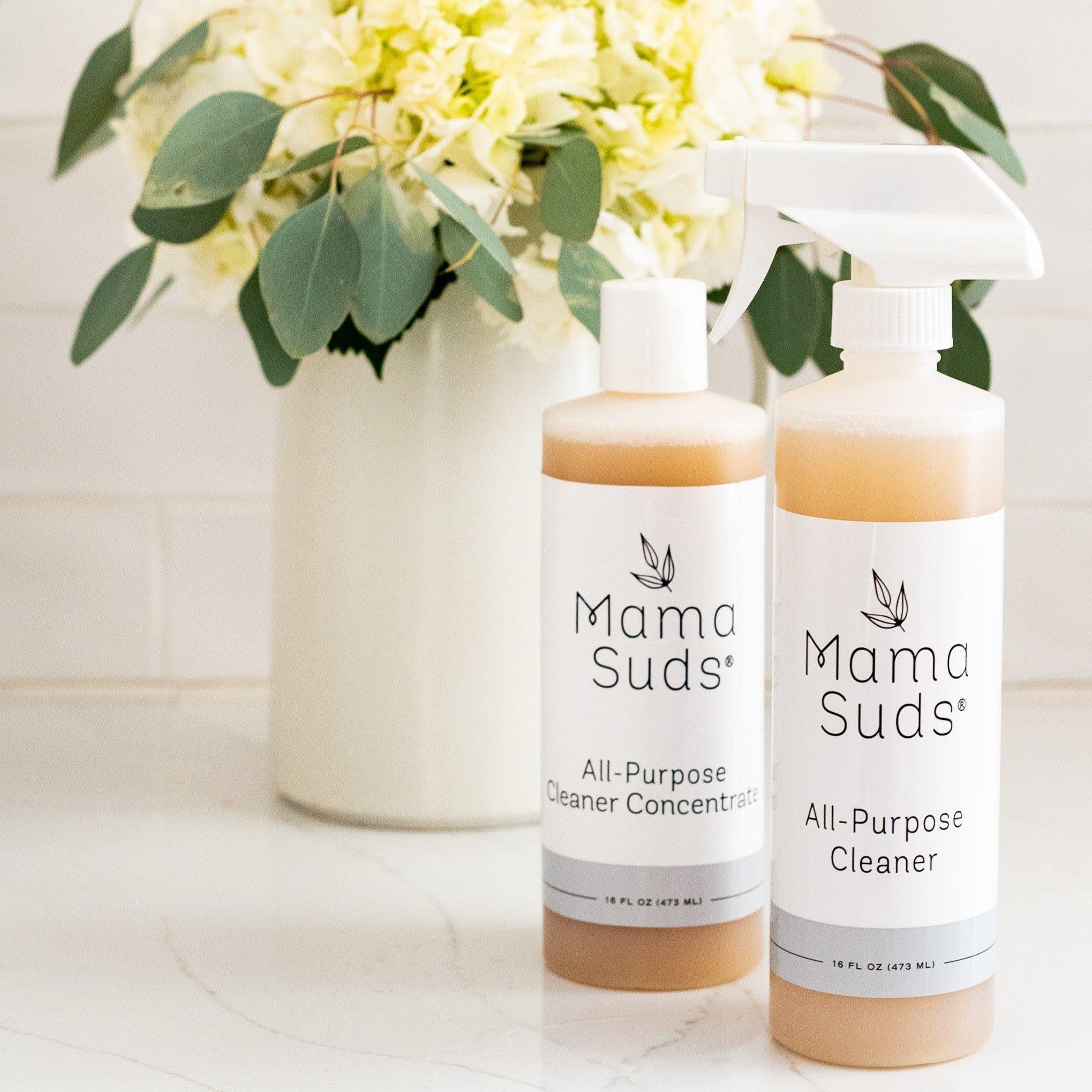 Mama Suds eco-friendly all-purpose cleaner bottles on counter with floral bouquet, Qu!rk Boutique