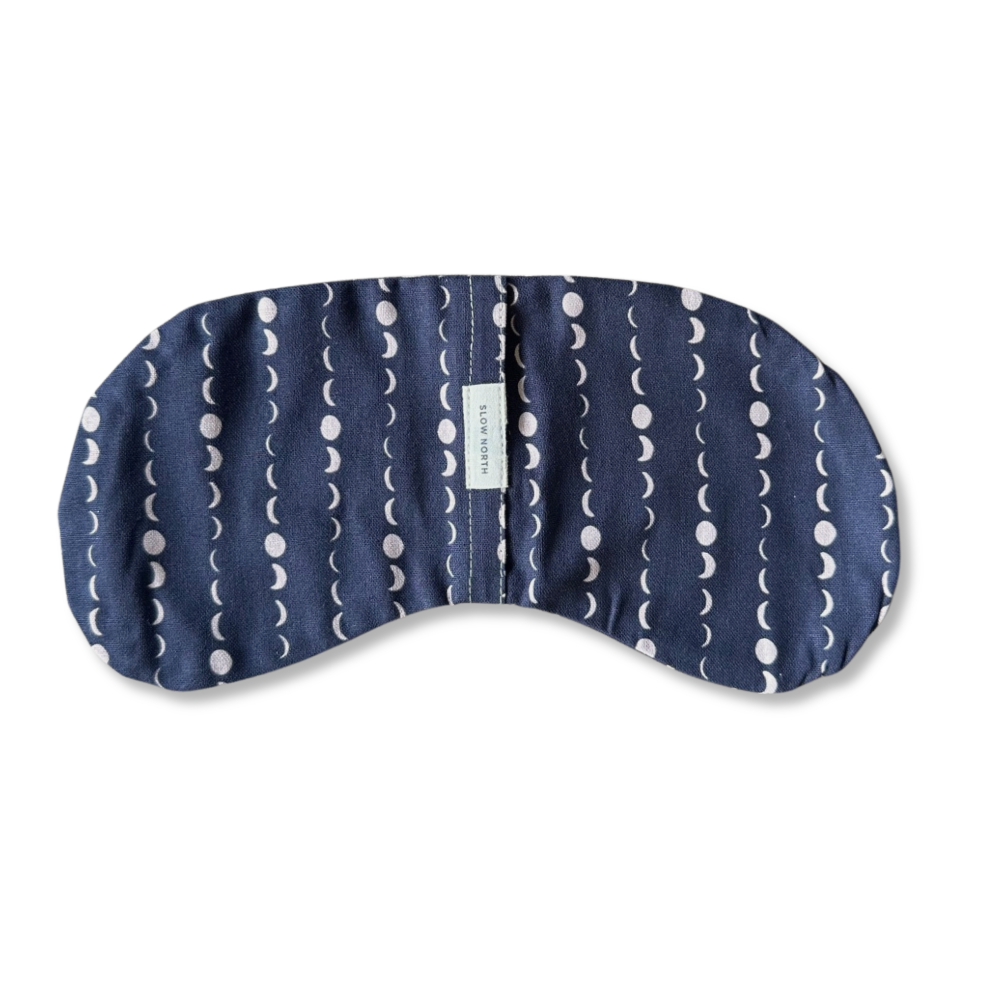 Navy blue eye mask with white moon phase pattern and Slow North label