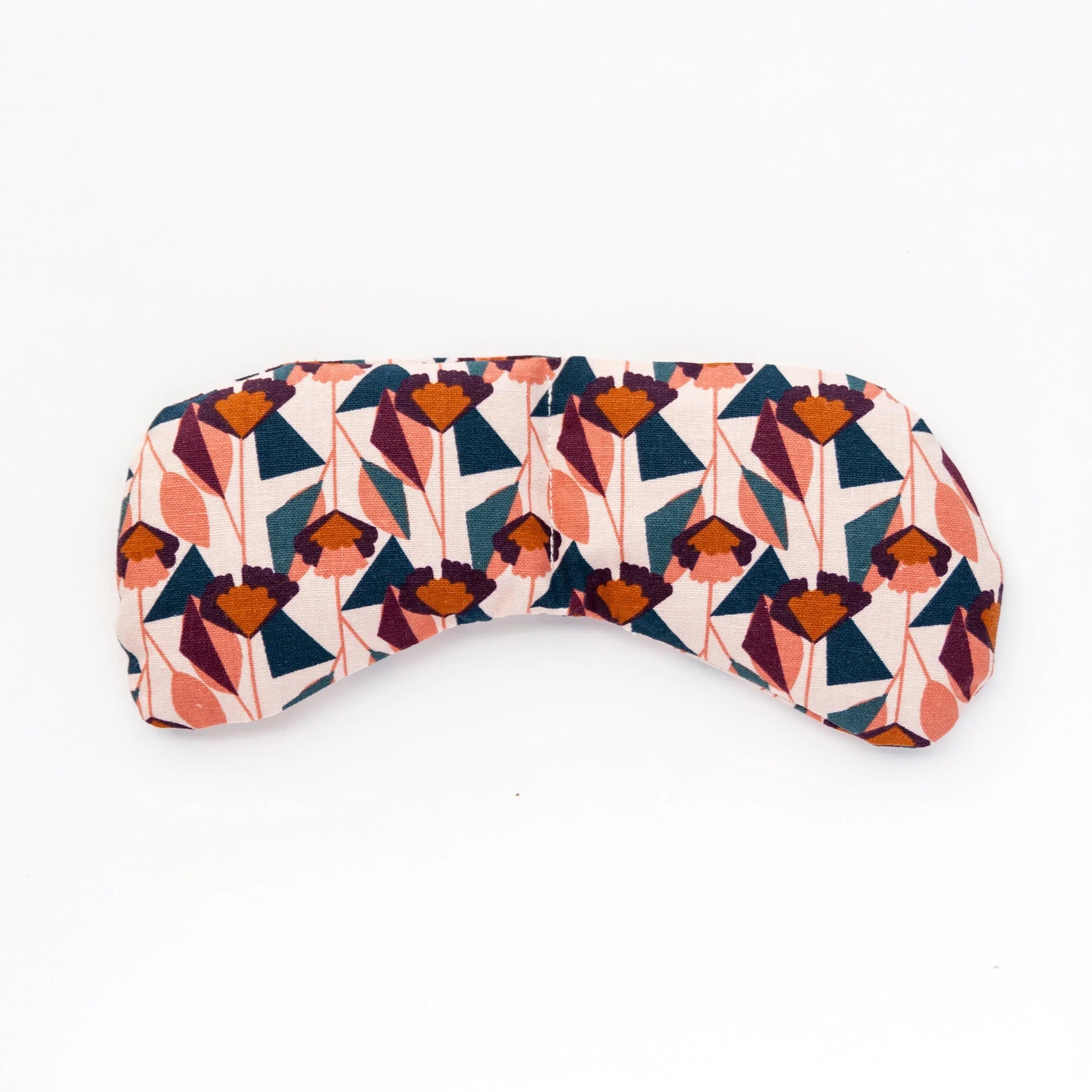 Blush floral patterned fabric eye mask on white background