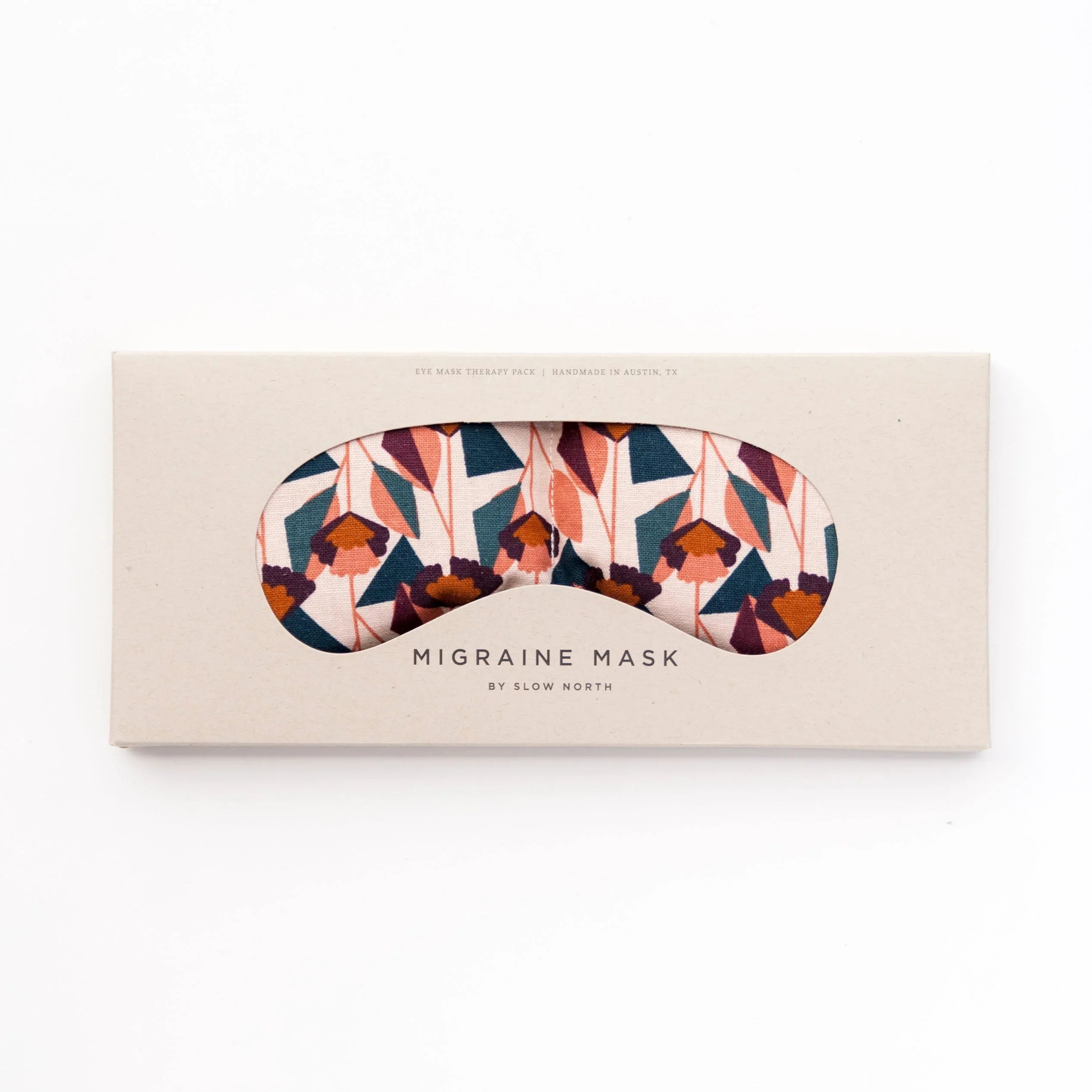 Floral-patterned migraine eye mask in blush tones in beige packaging by Slow North