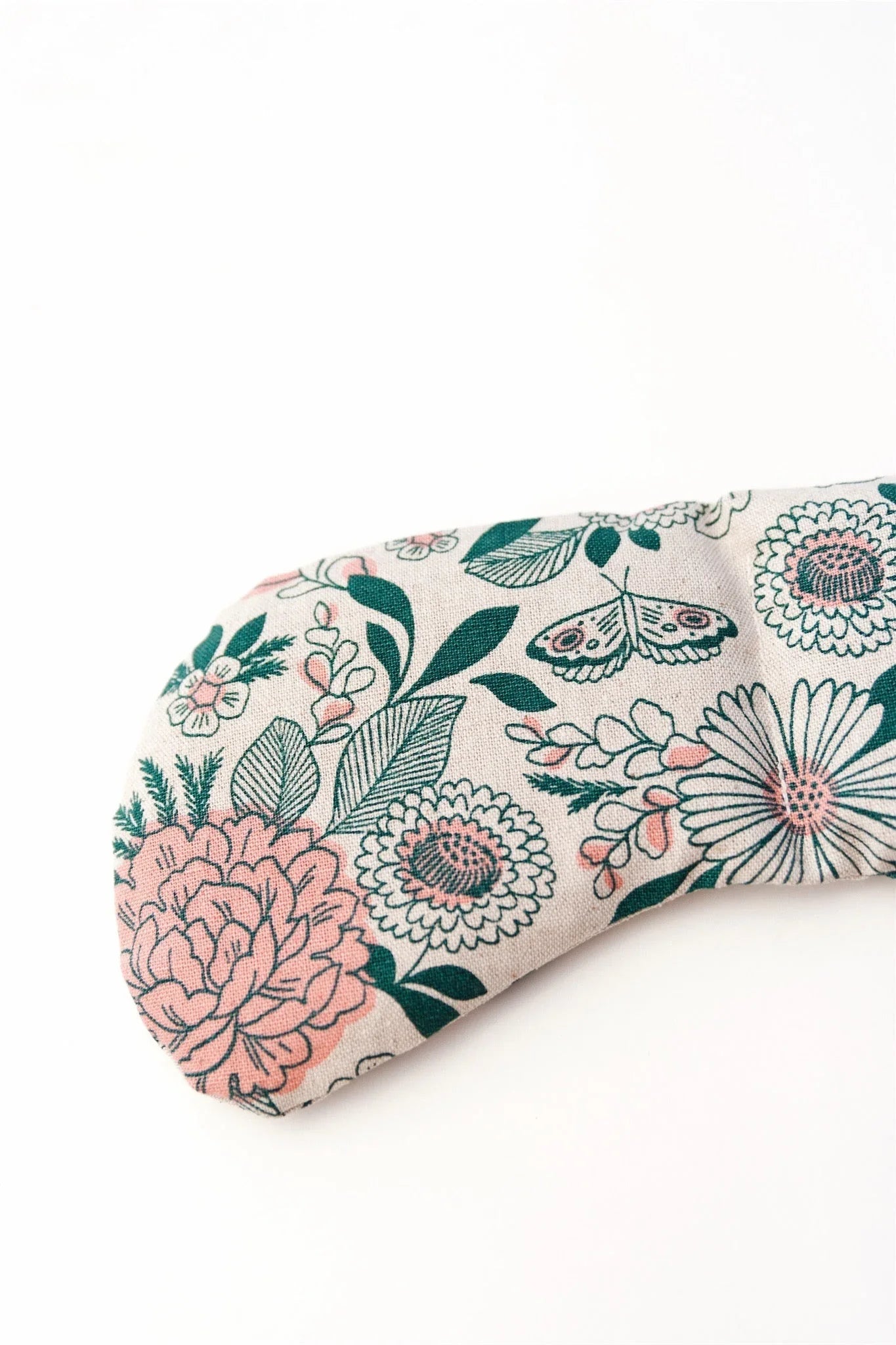 Floral patterned eye mask with pink and green flowers and butterfly on white background