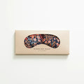Floral patterned migraine therapy eye mask in beige packaging by Slow North on white background