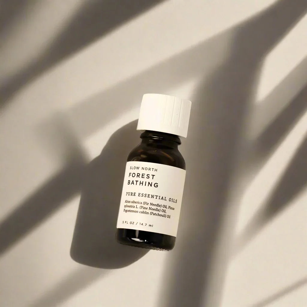 Slow North Forest Bathing essential oil diffuser blend bottle on neutral background with shadows