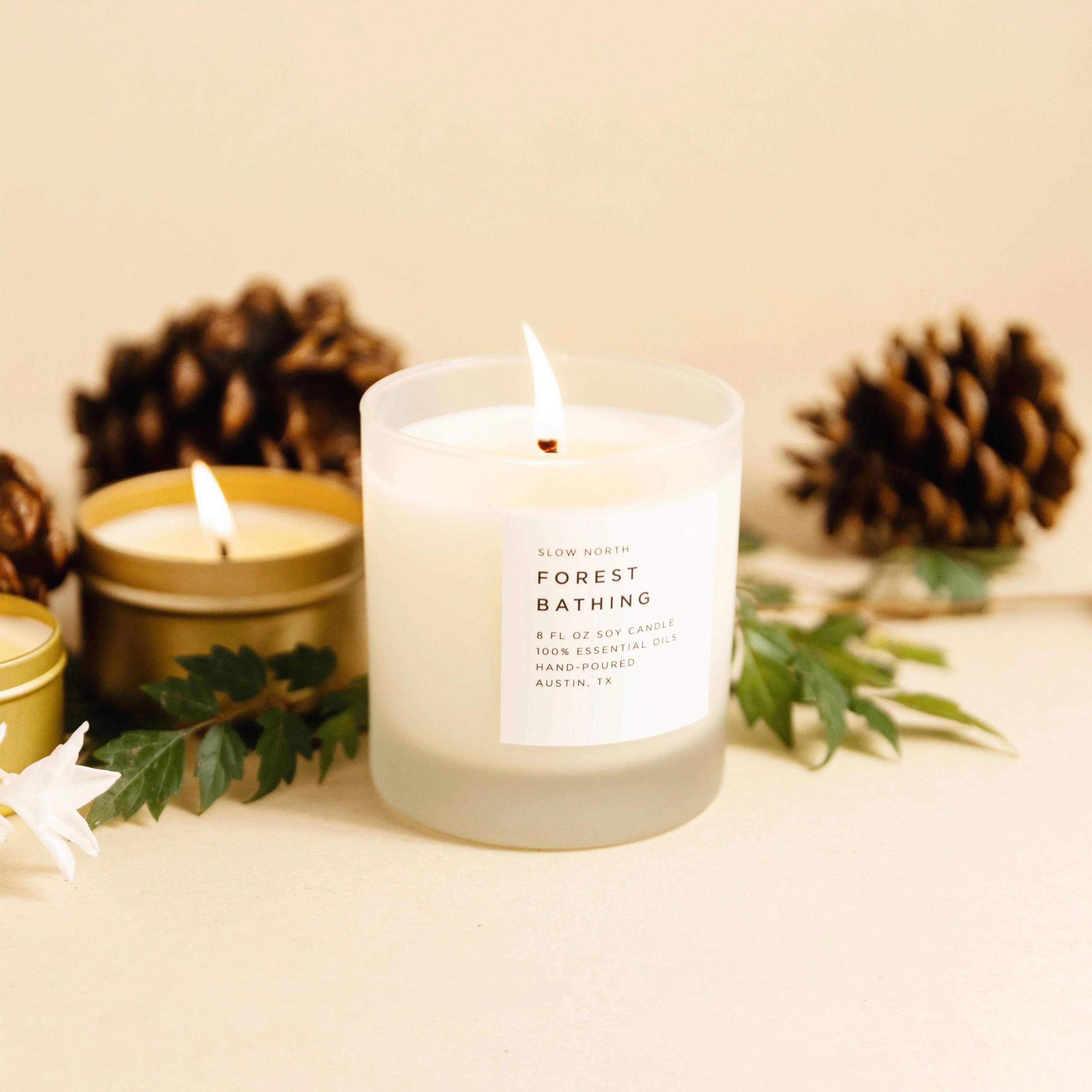 Forest Bathing soy candle in frosted glass with pinecones and greenery, Qu!rk Boutique gift