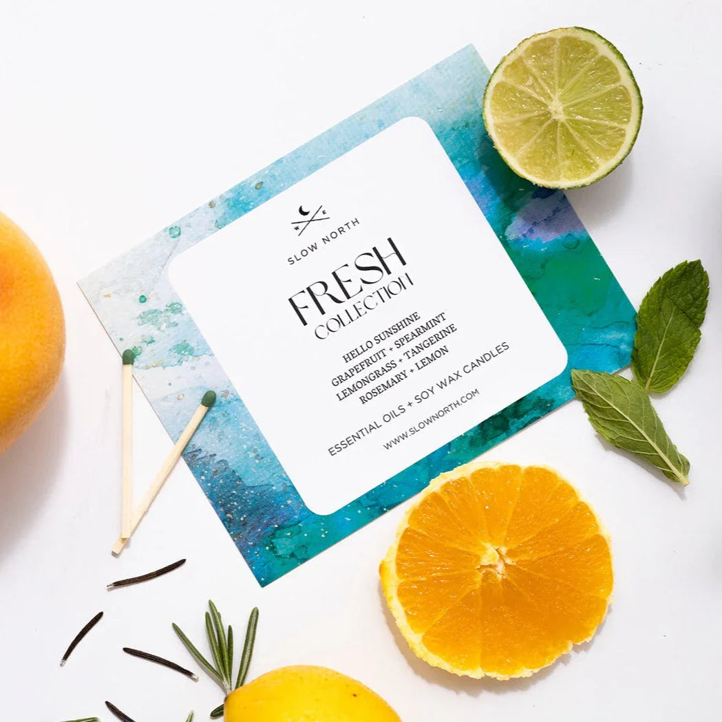 Slow North Fresh Collection card with grapefruit, spearmint, lemongrass, tangerine, lemon, and matches on white background