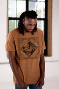 Man wearing a brown Qu!rk Boutique t-shirt with 'Go Outside' mountain graphic design