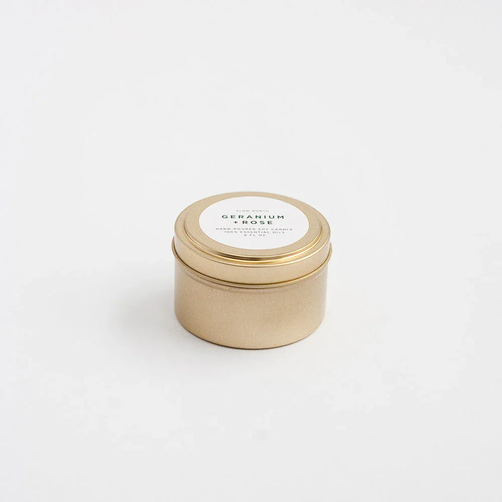 Geranium Rose travel tin candle in gold metal container on white background at Qu!rk Boutique