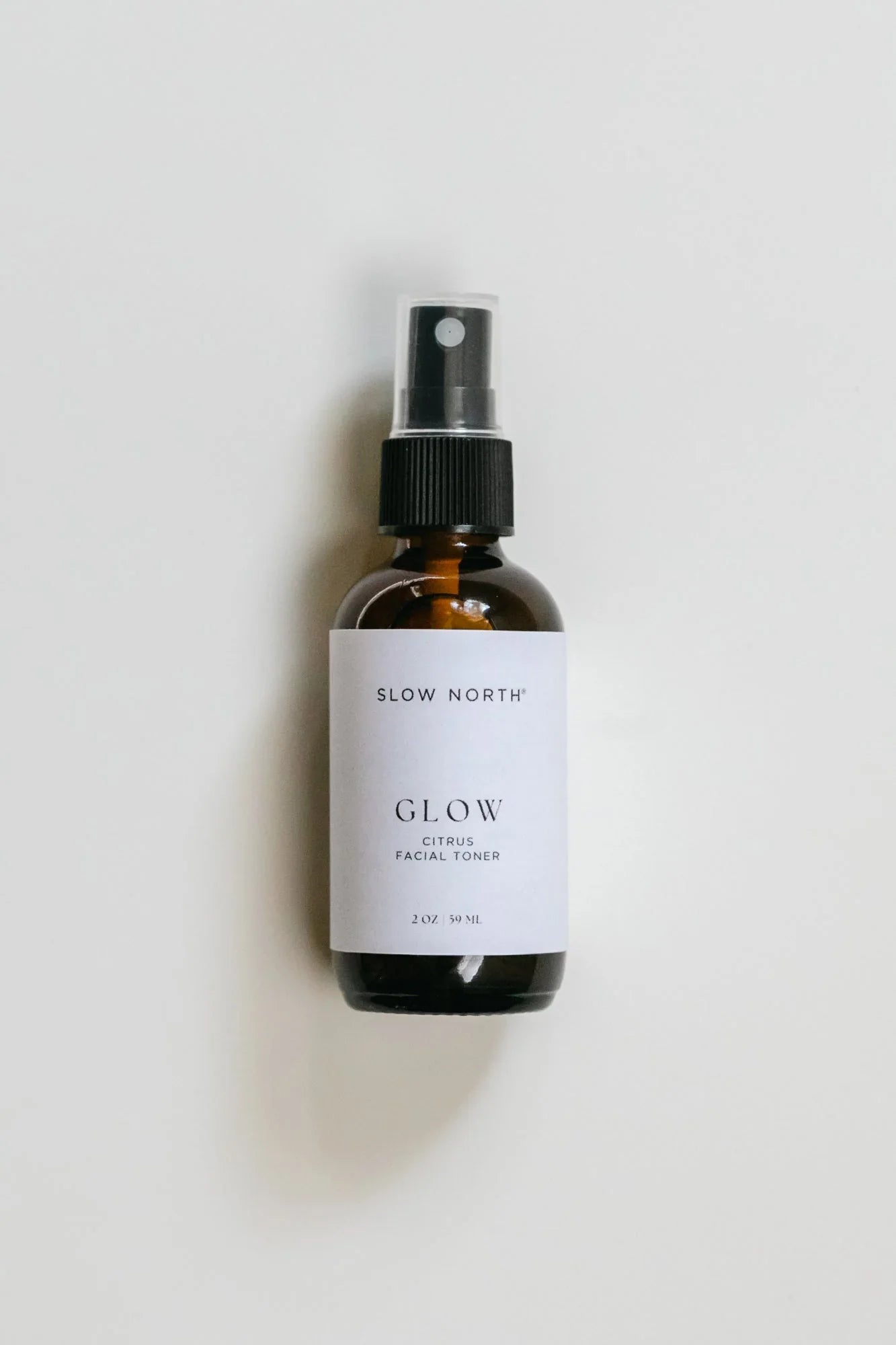 Slow North Glow citrus facial toner spray bottle on white background