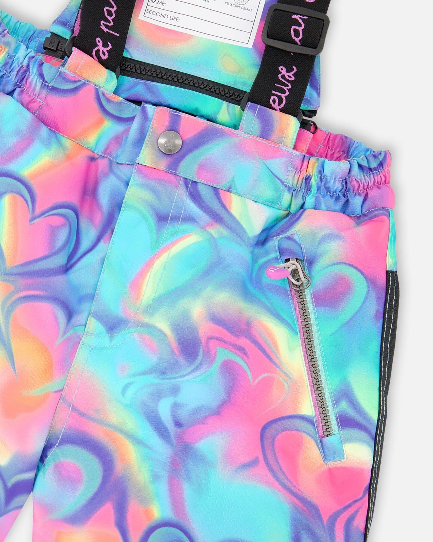 Close-up of colorful swirl print pants with zipper pocket and elastic waist at Qu!rk Boutique