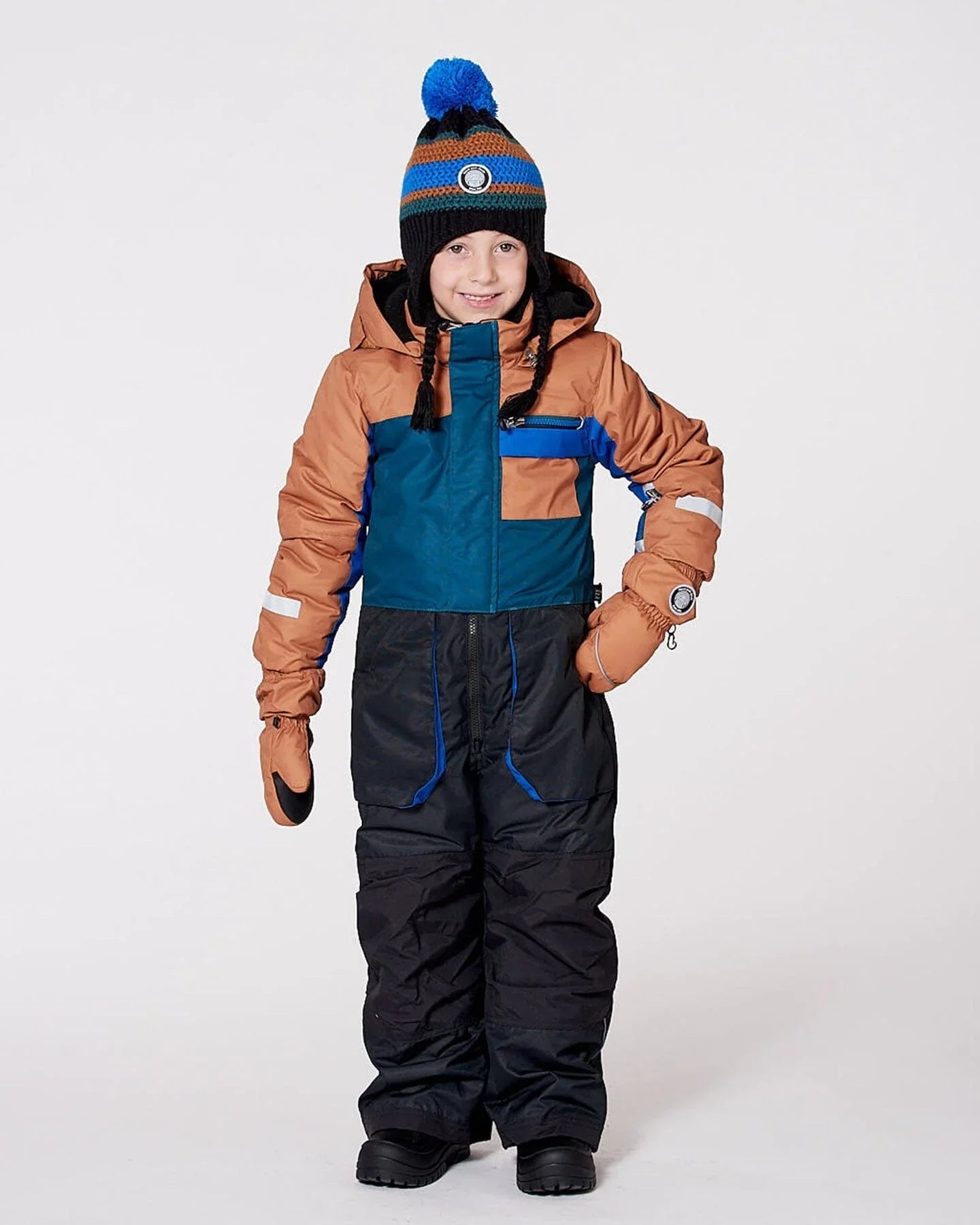 Child in colorblock snowsuit and striped pom-pom beanie, winter outerwear at Qu!rk Boutique