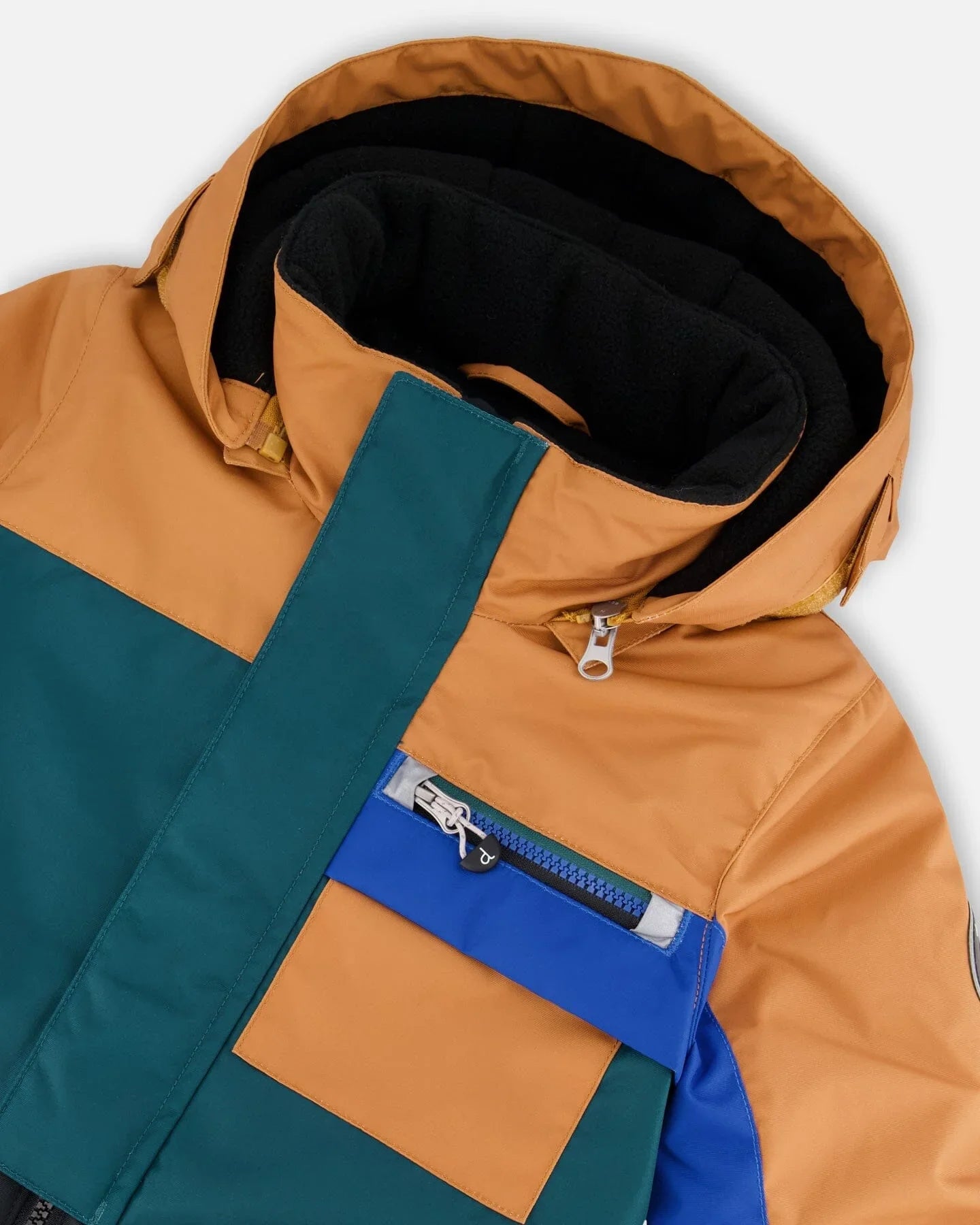 Colorblock winter jacket with mustard, teal, and blue panels, zip pocket, and high collar, Qu!rk Boutique