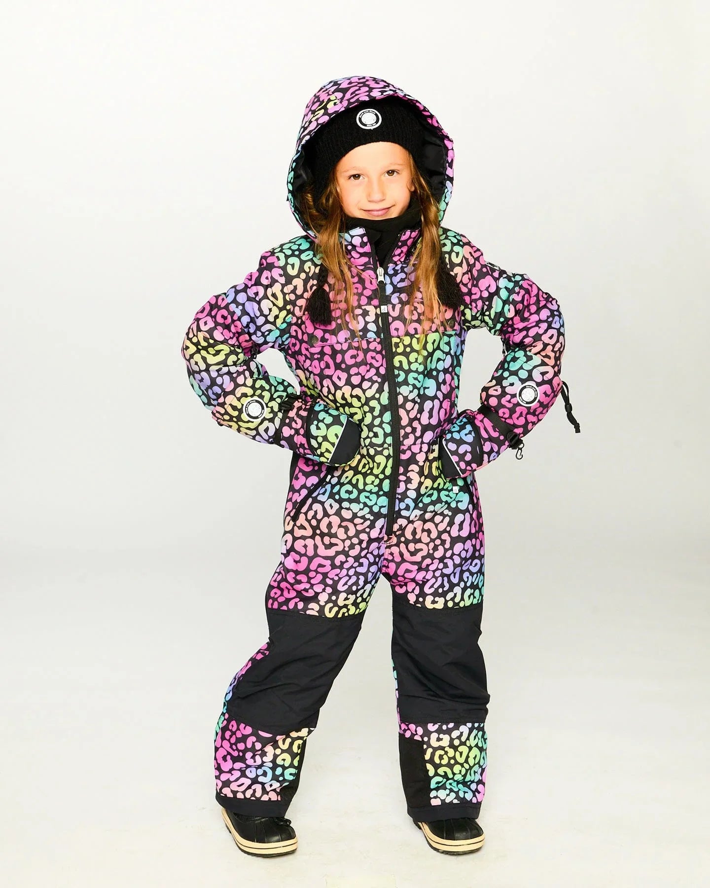 Child in colorful leopard print snowsuit and beanie from Qu!rk Boutique, winter fashion