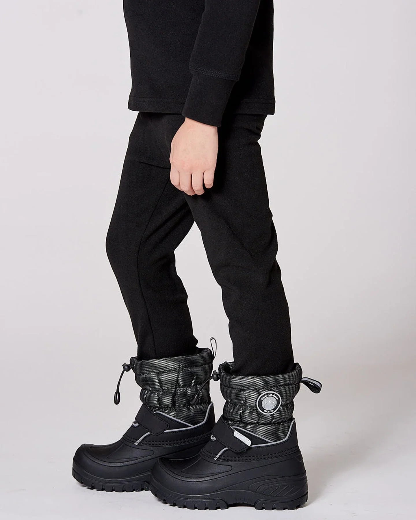 Black femme-fit winter boots with quilted cuffs, shown on model, Qu!rk Boutique footwear