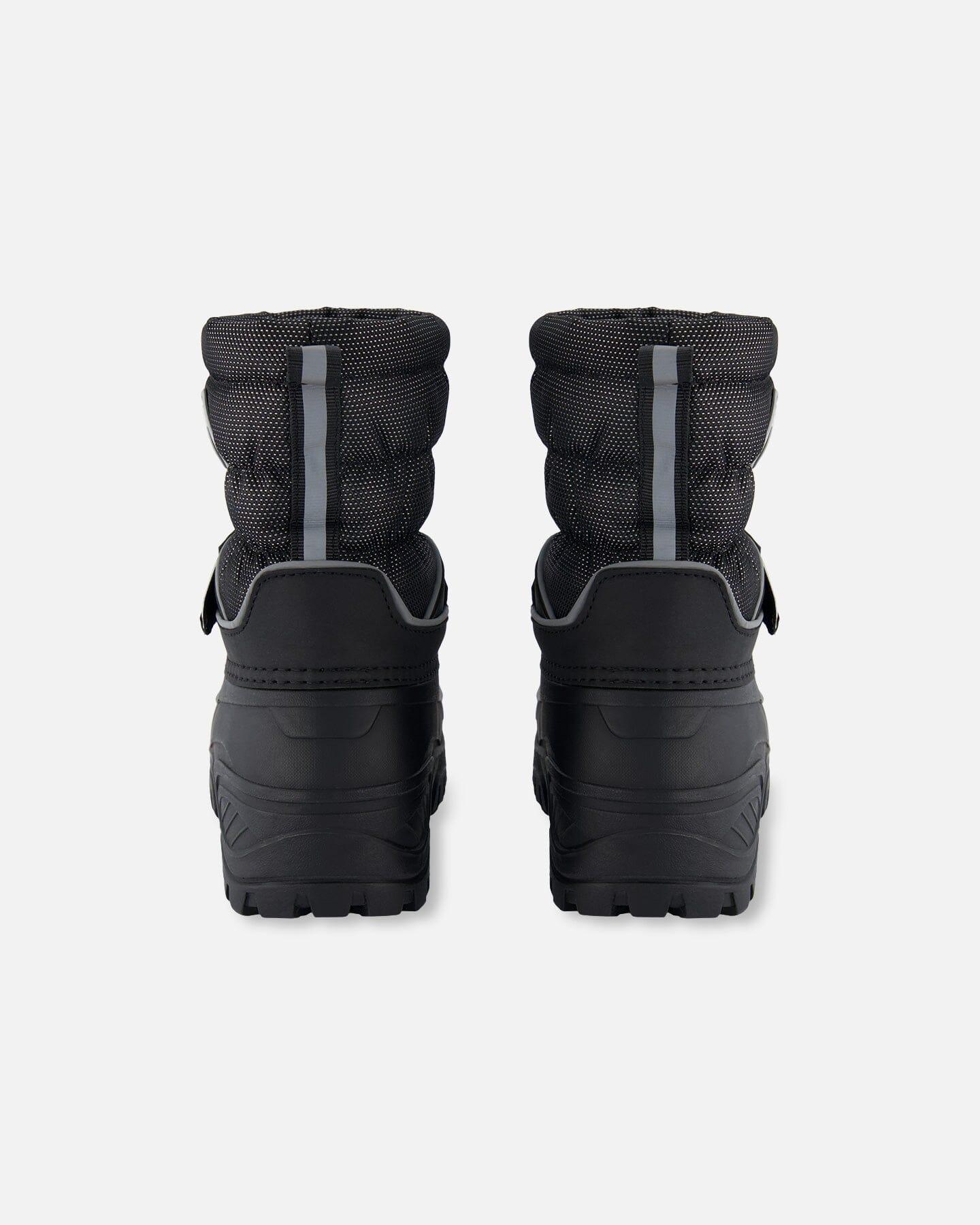 Back view of black quilted winter boots with reflective stripes, femme-fit, Qu!rk Boutique