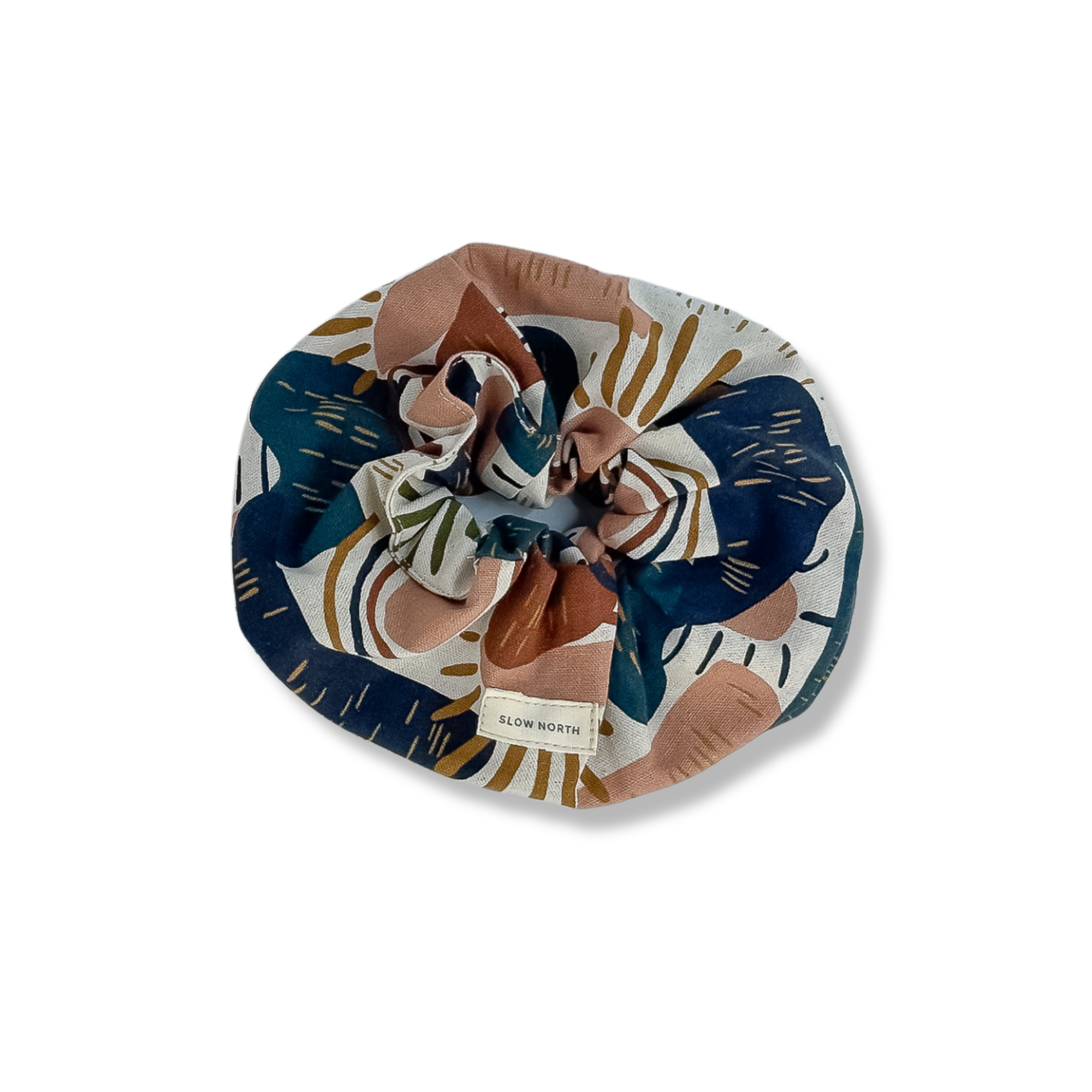 Slow North fabric hair scrunchie with abstract floral print in navy, brown, olive, and cream colors