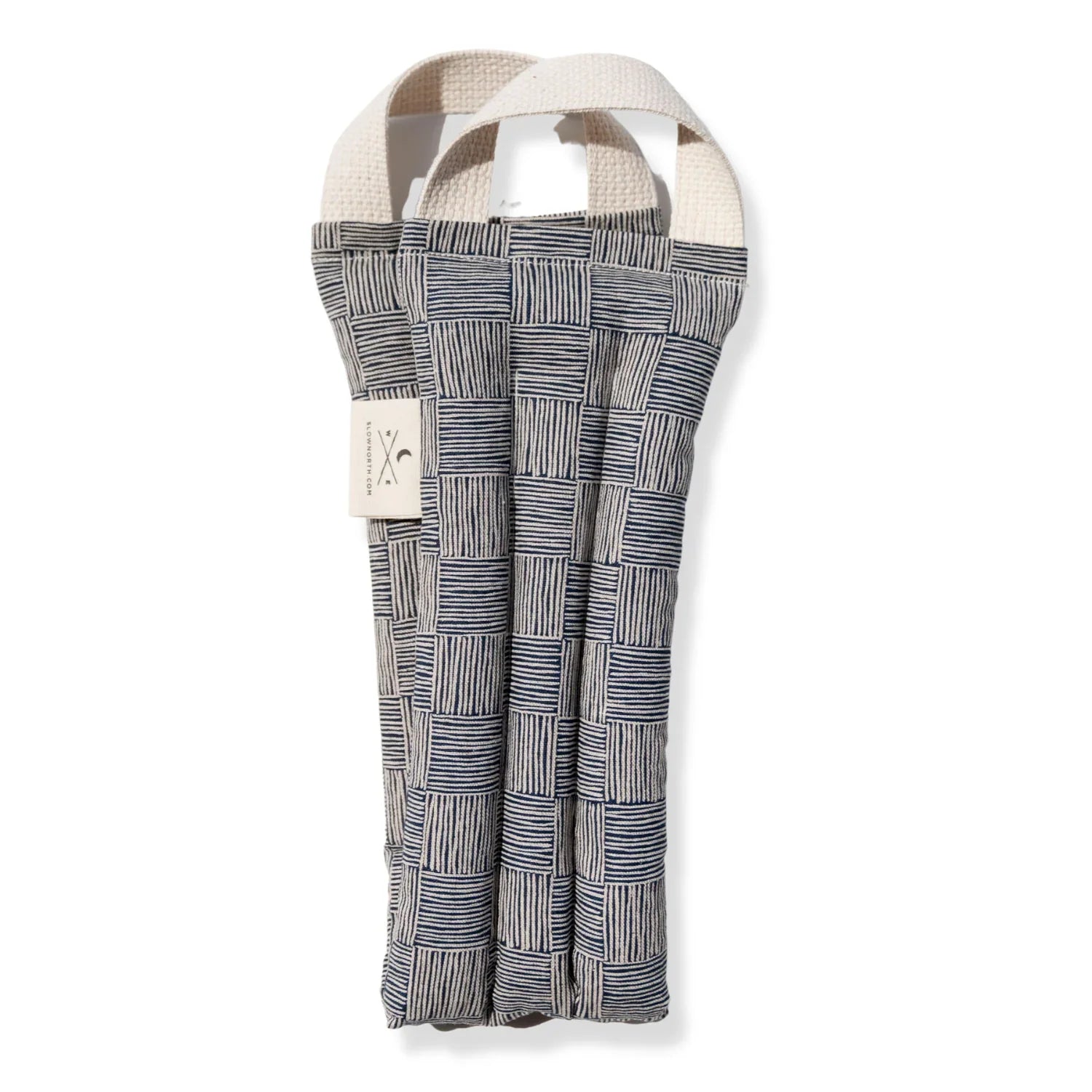 Heated neck wrap with blue and beige striped checkerboard pattern and beige fabric handles