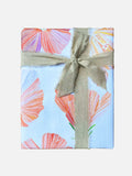 Gift wrapped in floral hibiscus patterned paper with beige linen ribbon bow