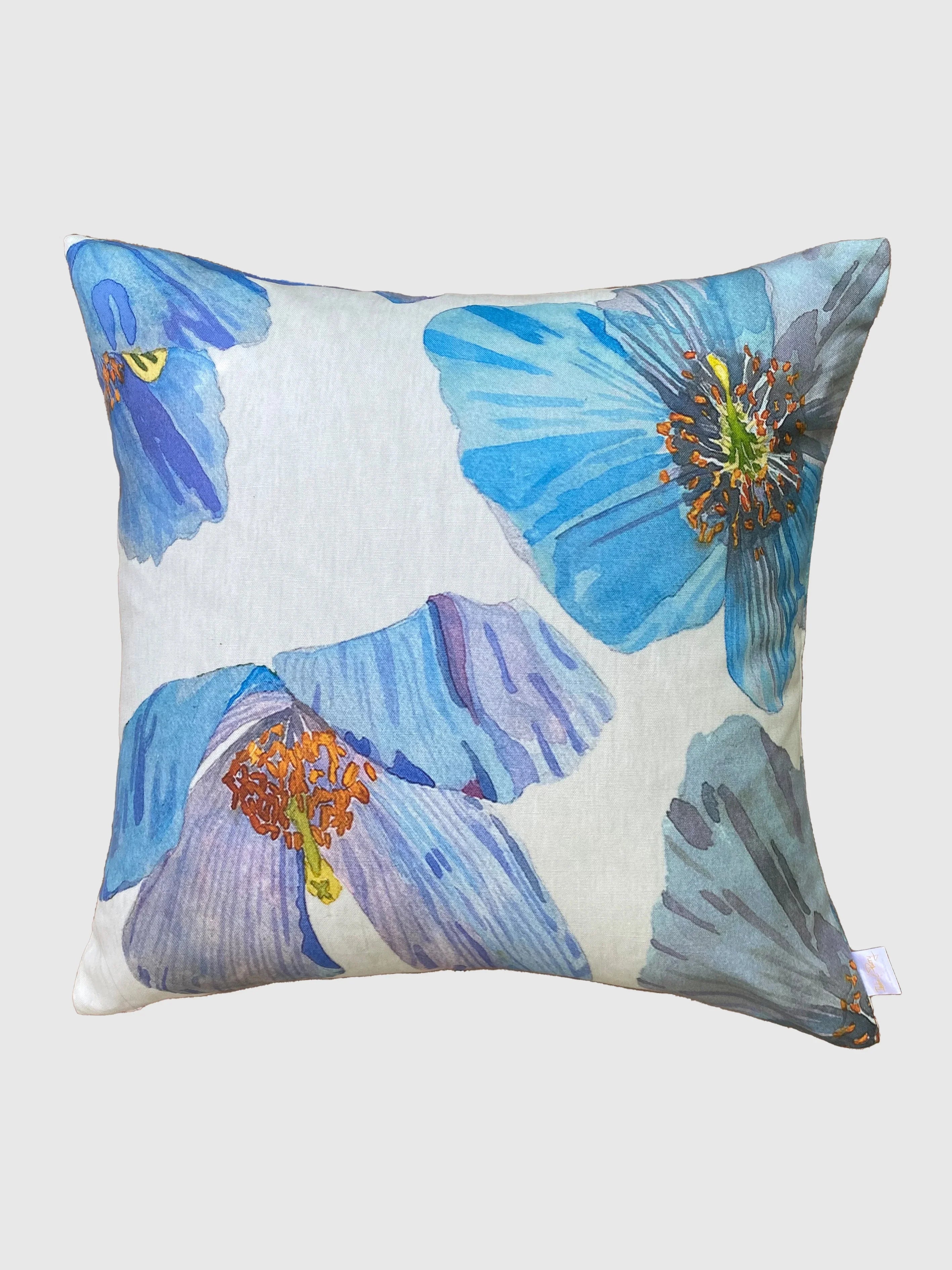 Decorative throw pillow with large blue Himalayan poppy floral print on white background