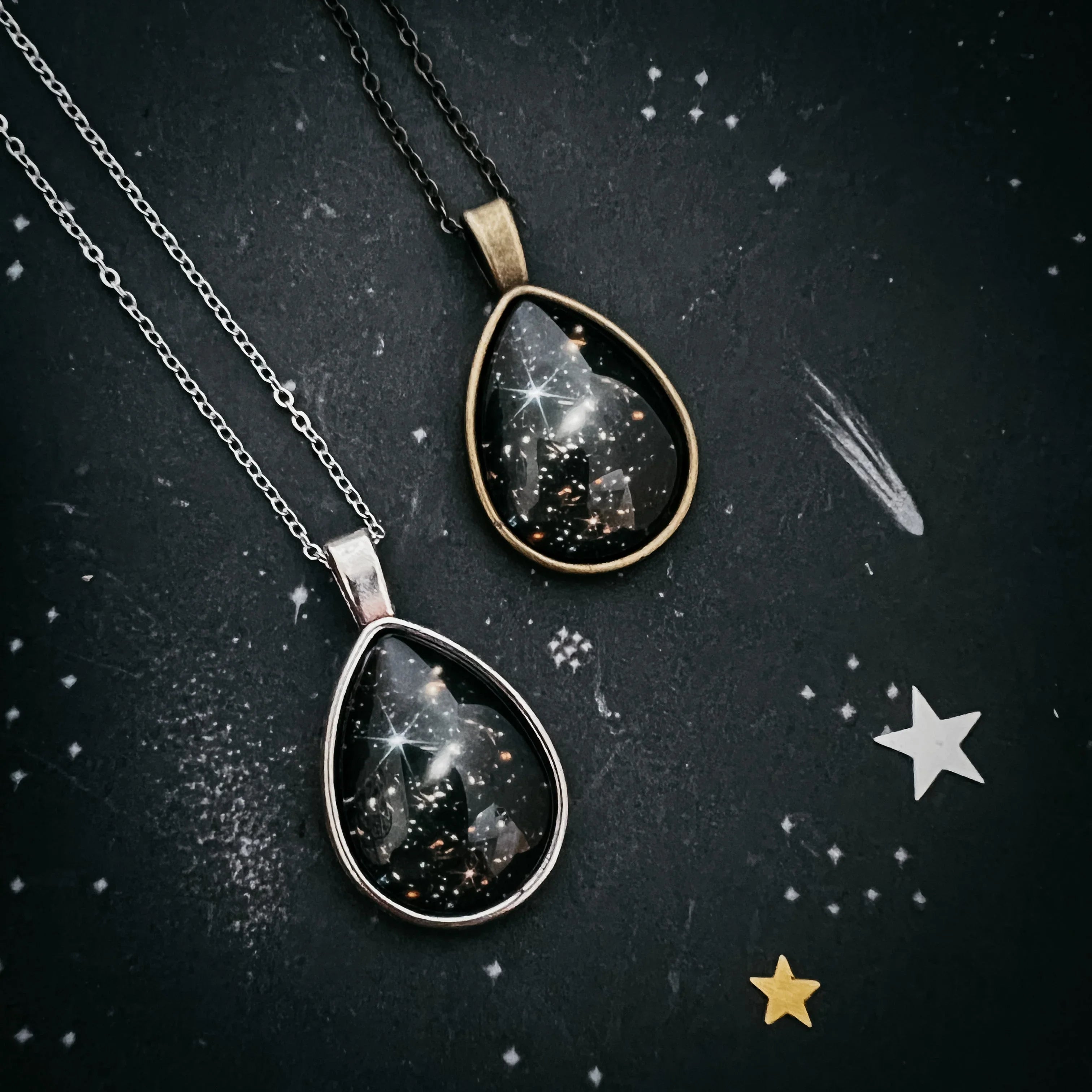 Cosmic teardrop galaxy necklaces on dark starry background from Qu!rk Boutique