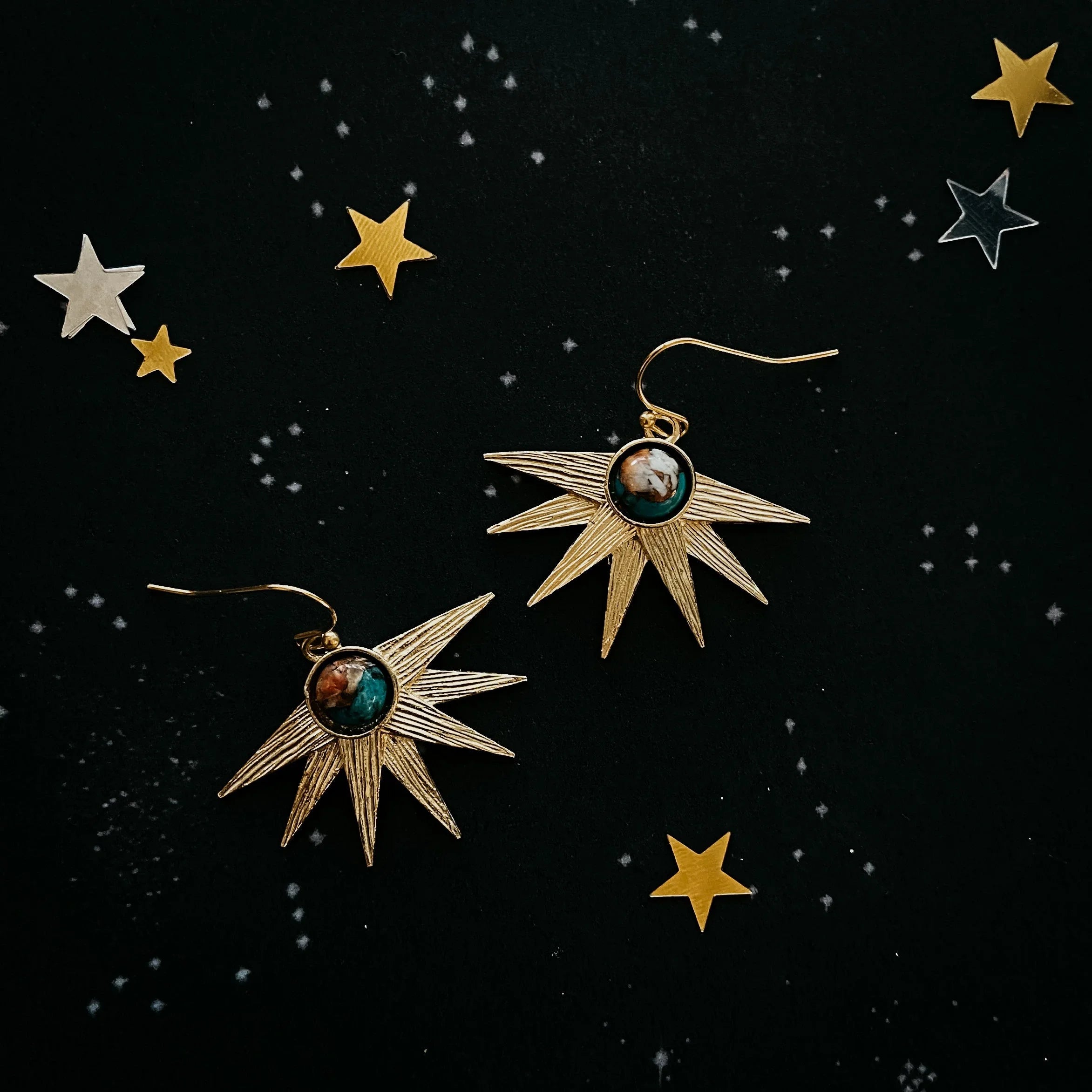 Gold starburst earrings with gemstone centers on celestial background, Qu!rk Boutique jewelry