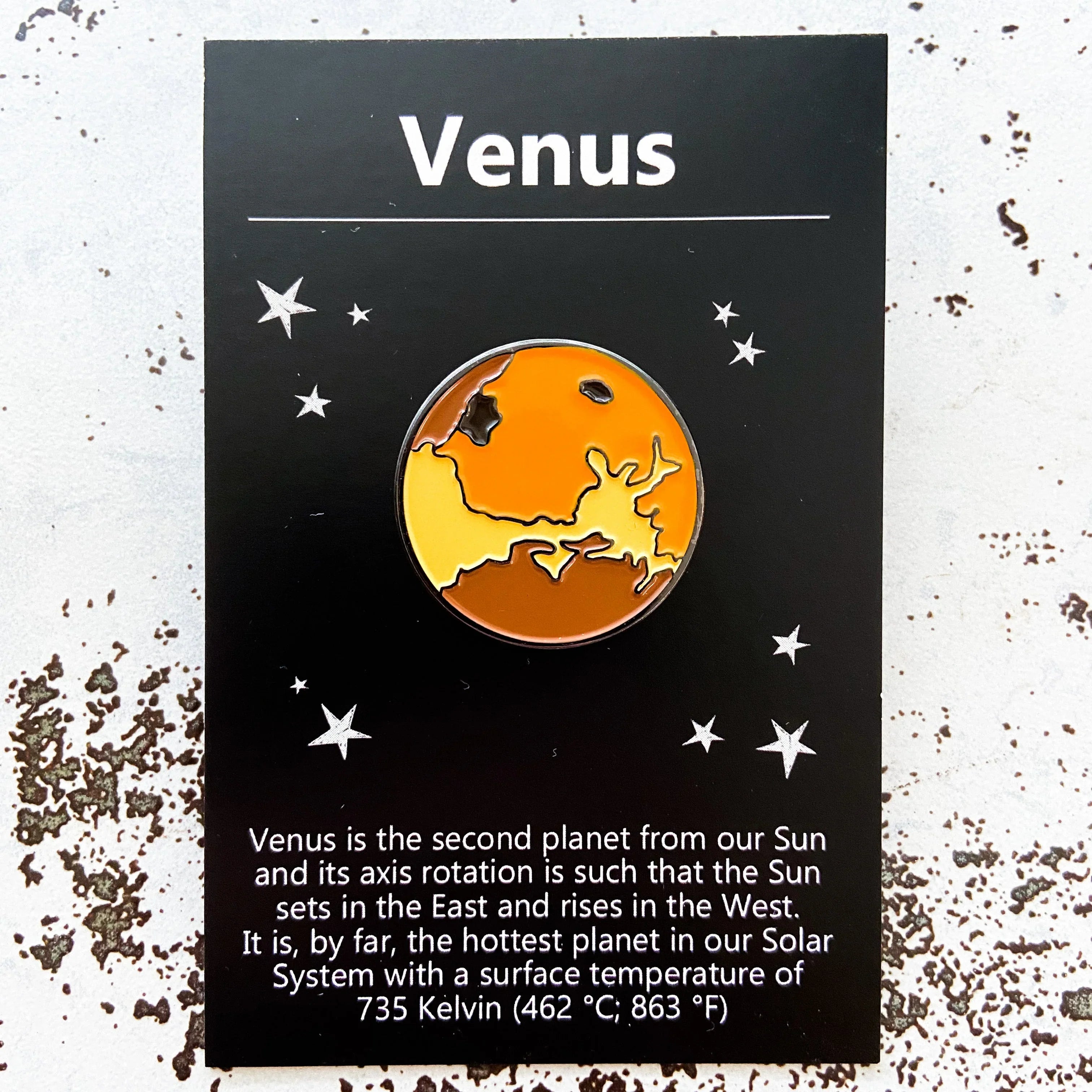 Enamel Venus planet pin on black card with stars and Venus facts about rotation and temperature