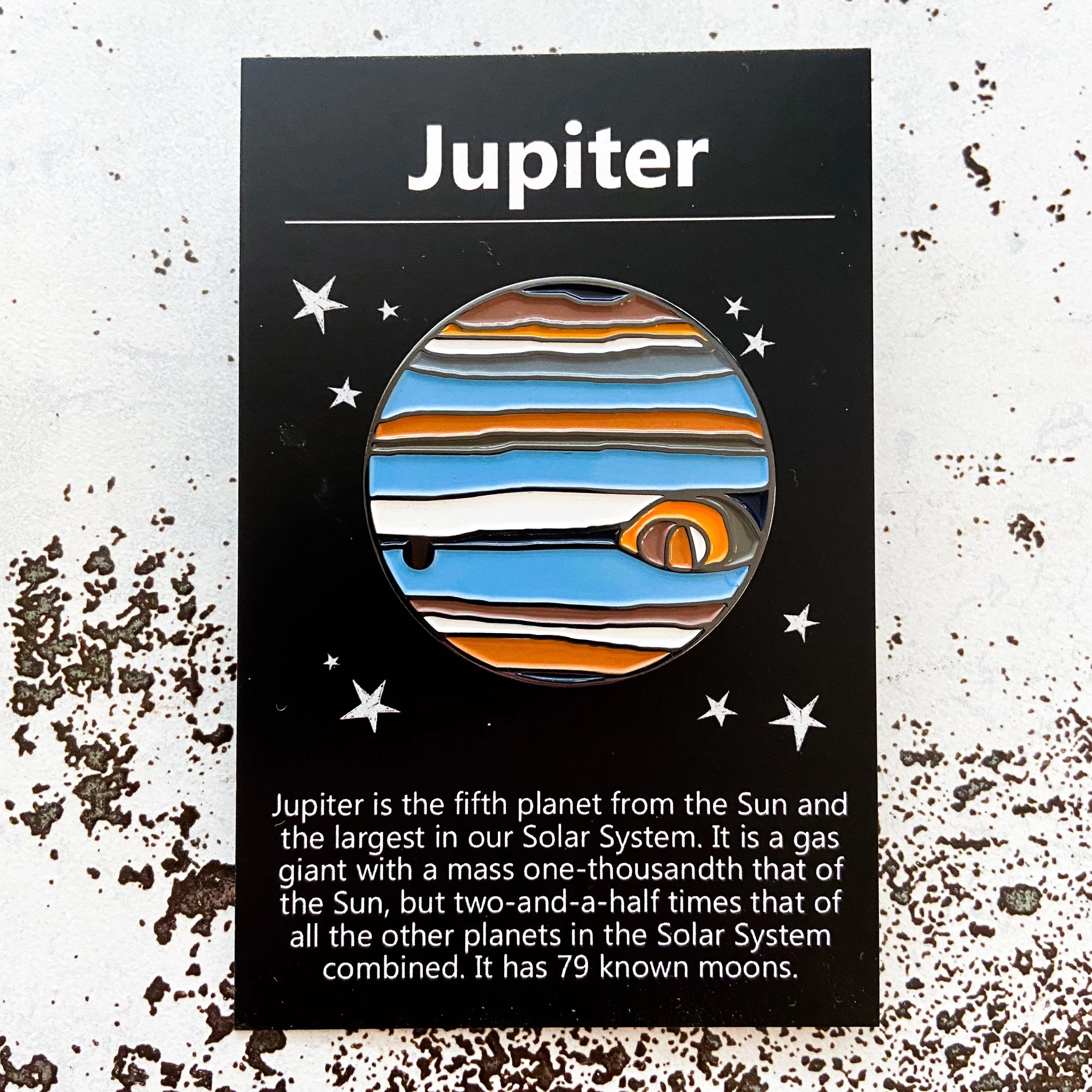Artist-designed Jupiter enamel pin on starry black card, cosmic jewelry at Qu!rk Boutique