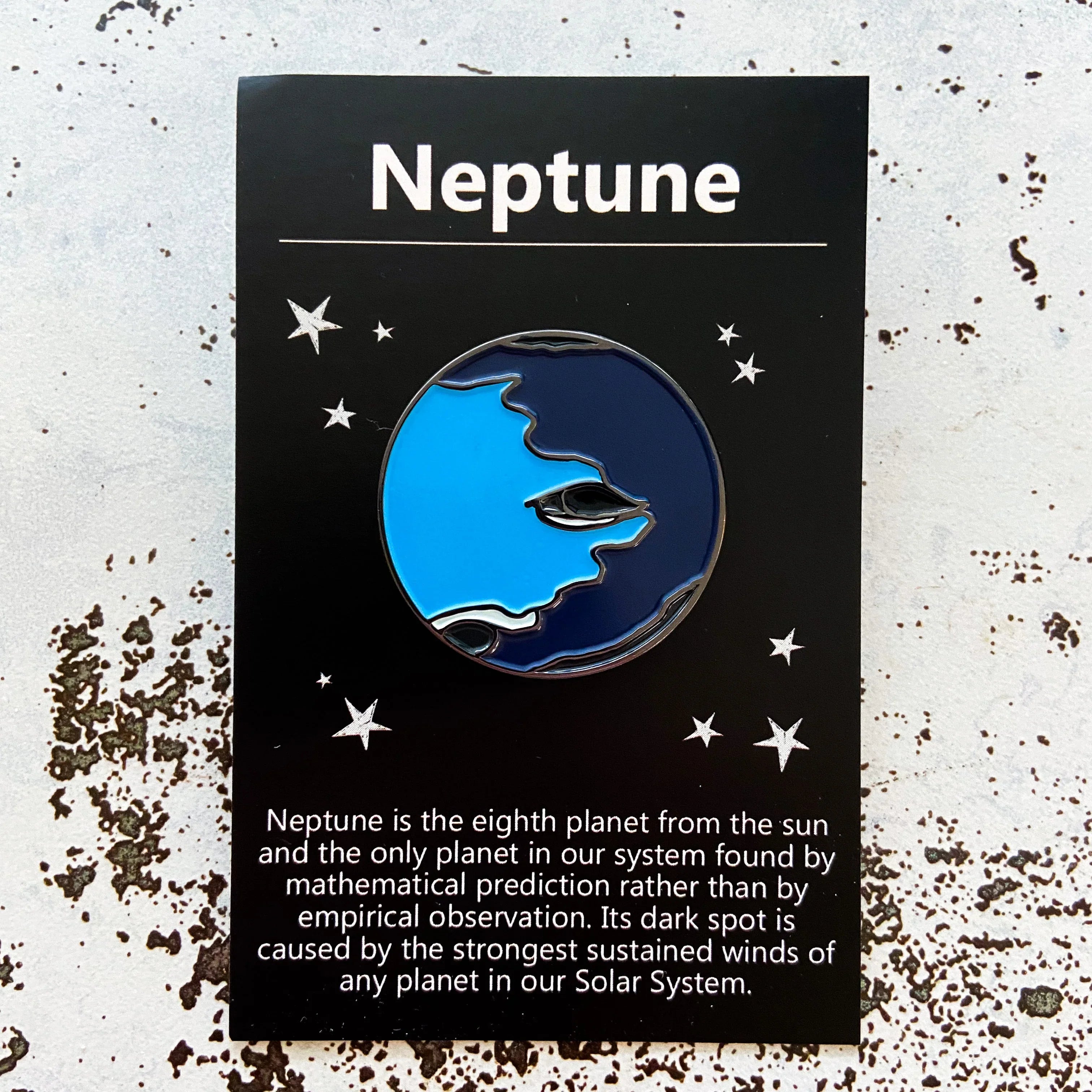 Neptune enamel pin on cosmic-themed card, artist-designed gift at Qu!rk Boutique