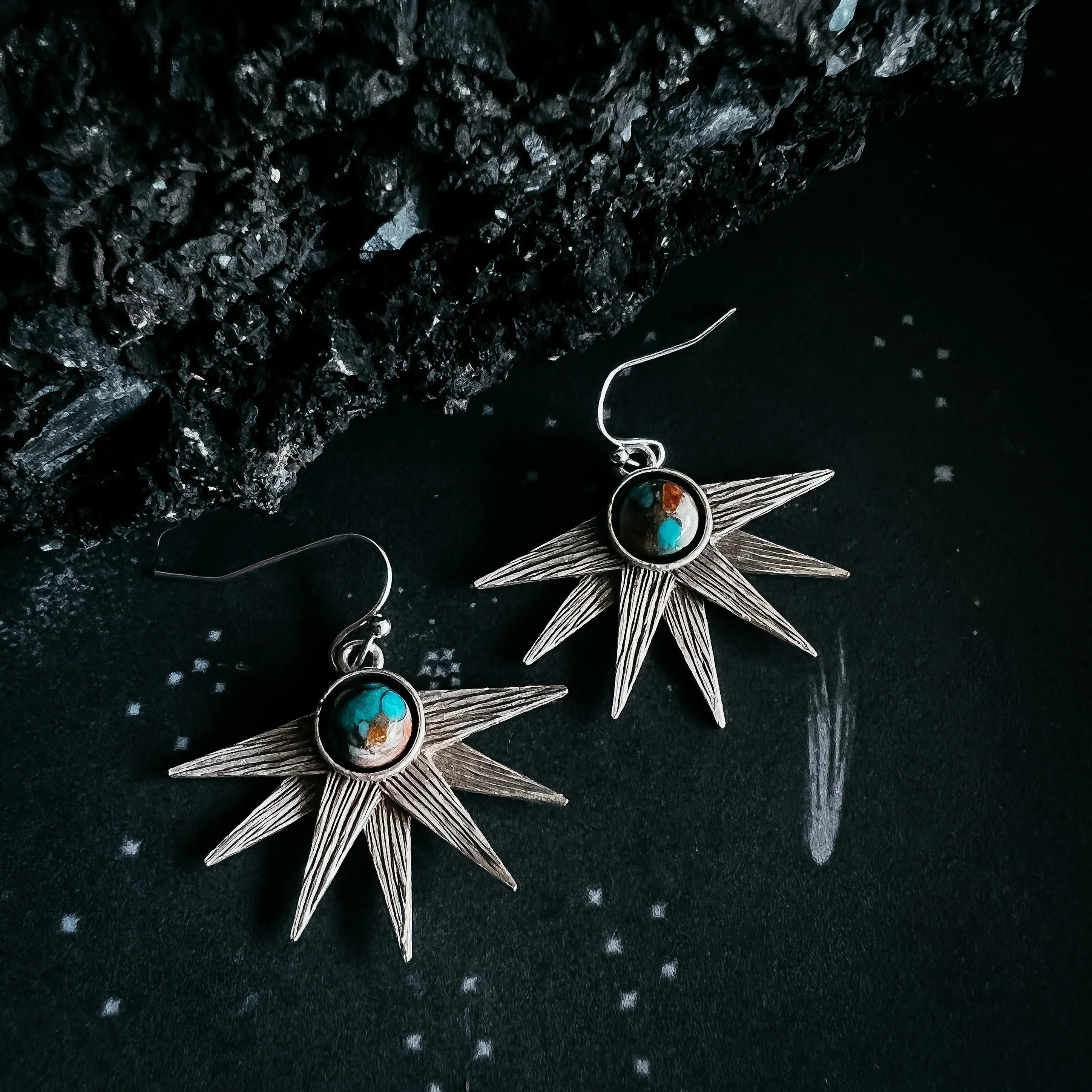 Starburst silver earrings with turquoise detail on black cosmic background, Qu!rk Boutique