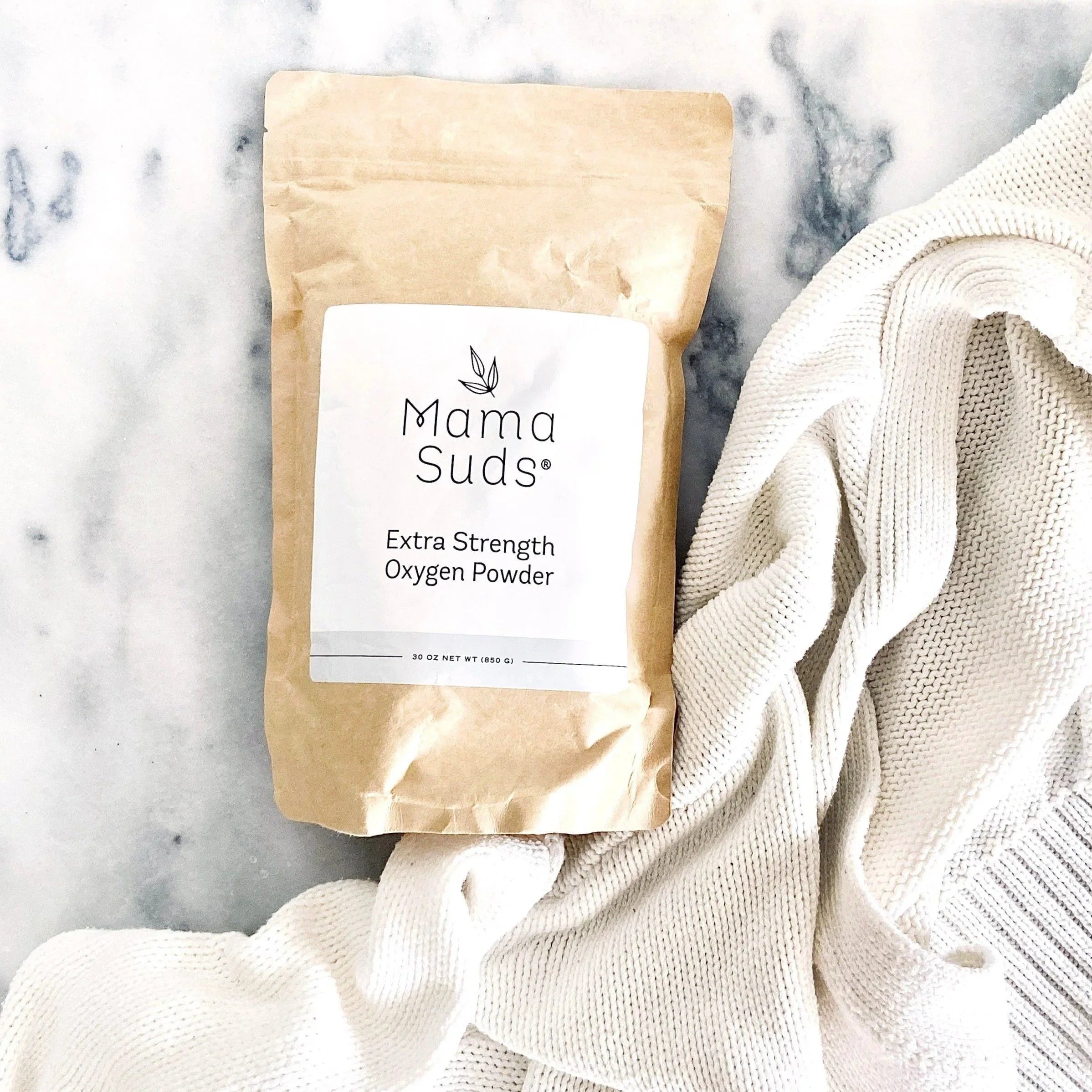 Mama Suds Extra Strength Oxygen Powder eco-friendly laundry detergent on white knit blanket