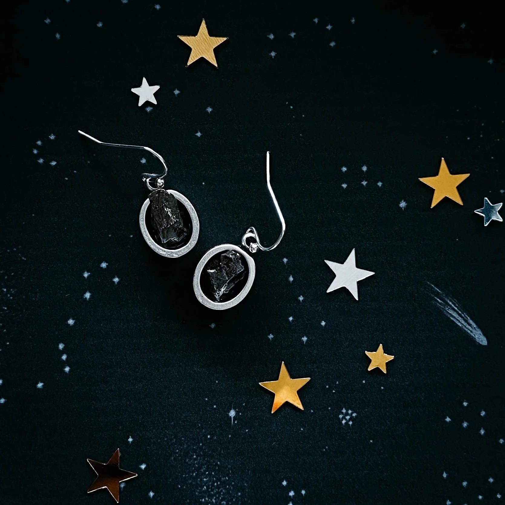 Raw crystal dangle earrings on cosmic starry background, Qu!rk Boutique artist-designed jewelry
