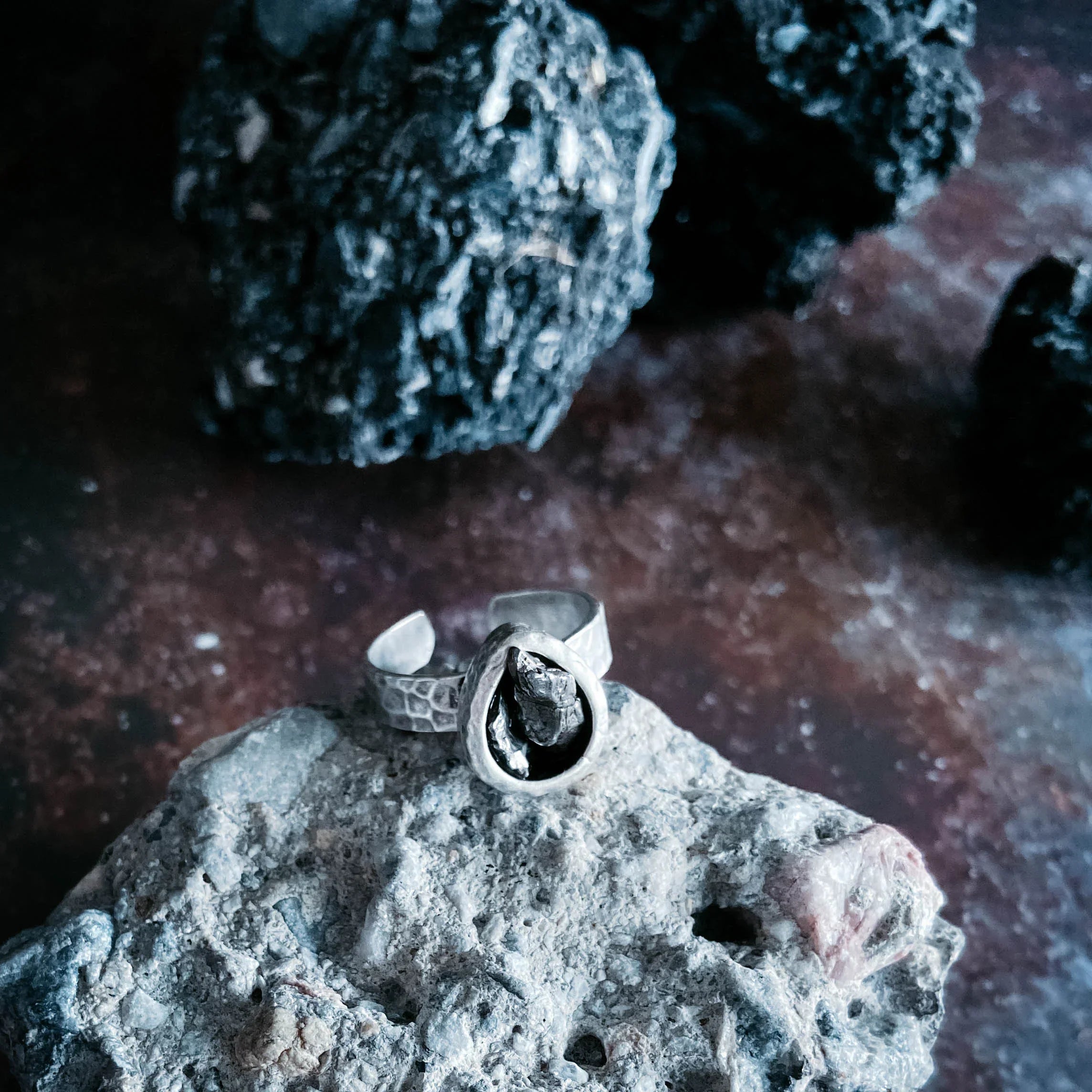 Handmade silver ring with raw stone detail on textured rock, Qu!rk Boutique cosmic jewelry
