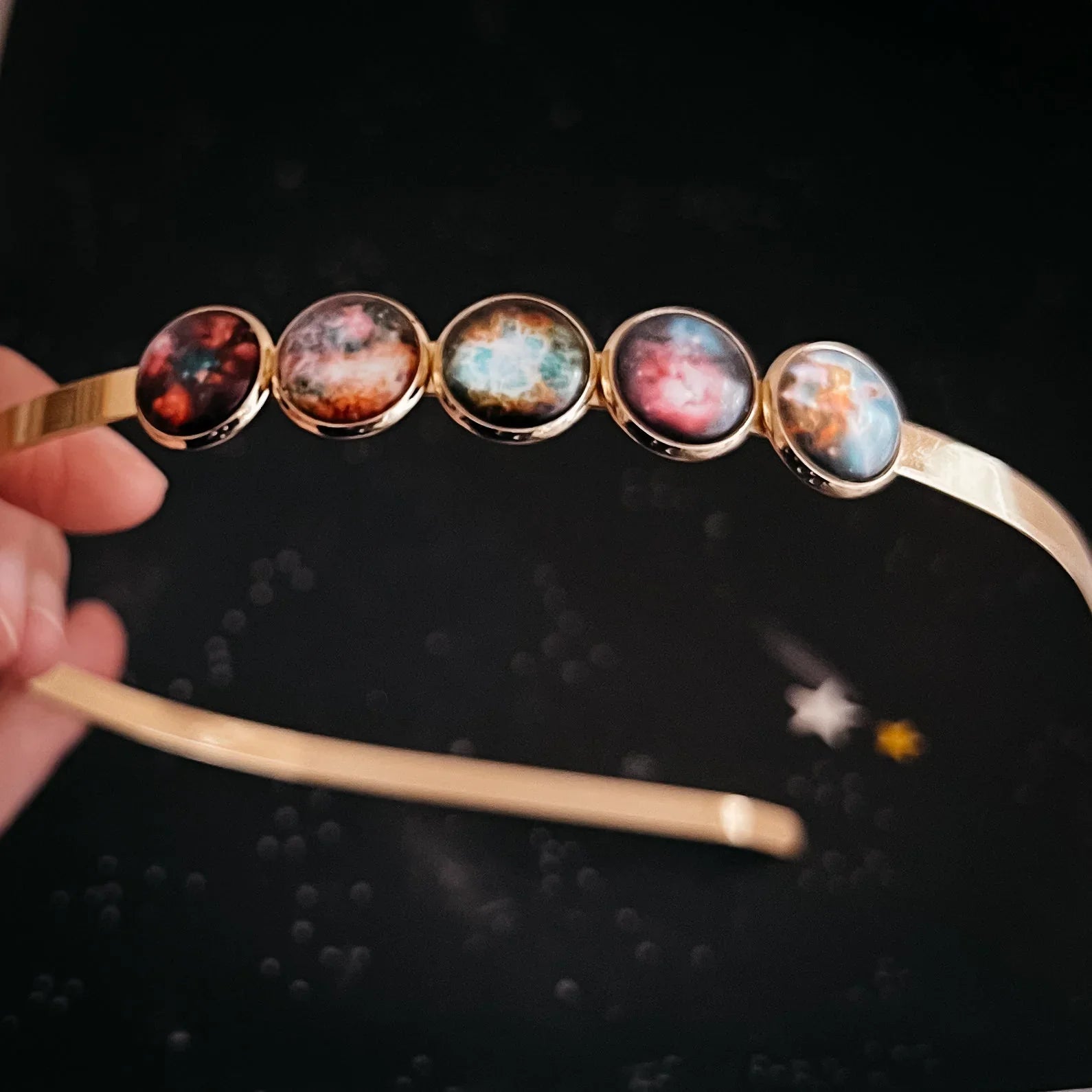 Gold headband with five galaxy-themed cabochons, cosmic couture accessory from Qu!rk Boutique