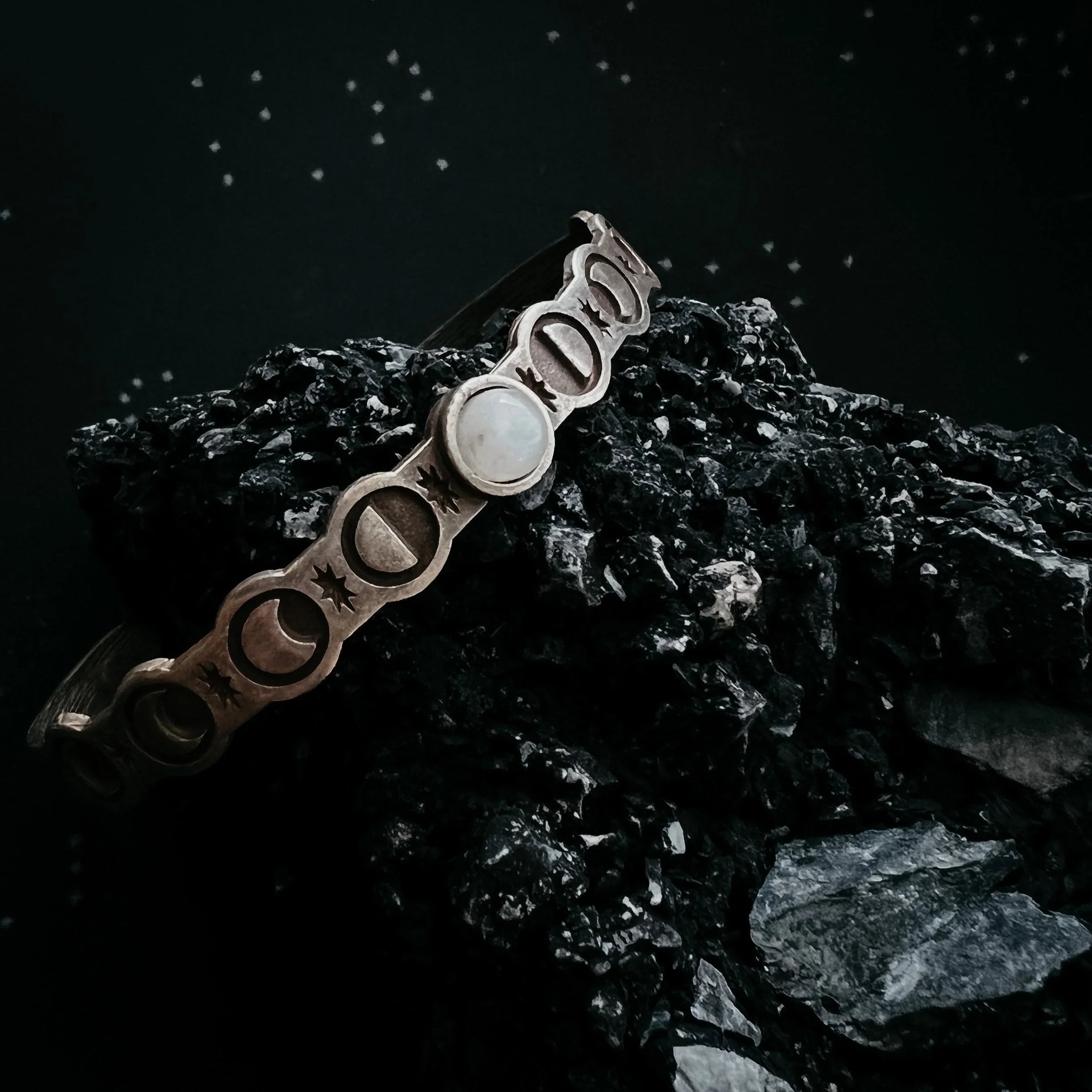 Moon phase cuff bracelet with gemstone on black stone, cosmic jewelry at Quirk Boutique
