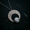 Cosmic-inspired silver pendant necklace with round white stone, artisan jewelry at Qu!rk Boutique