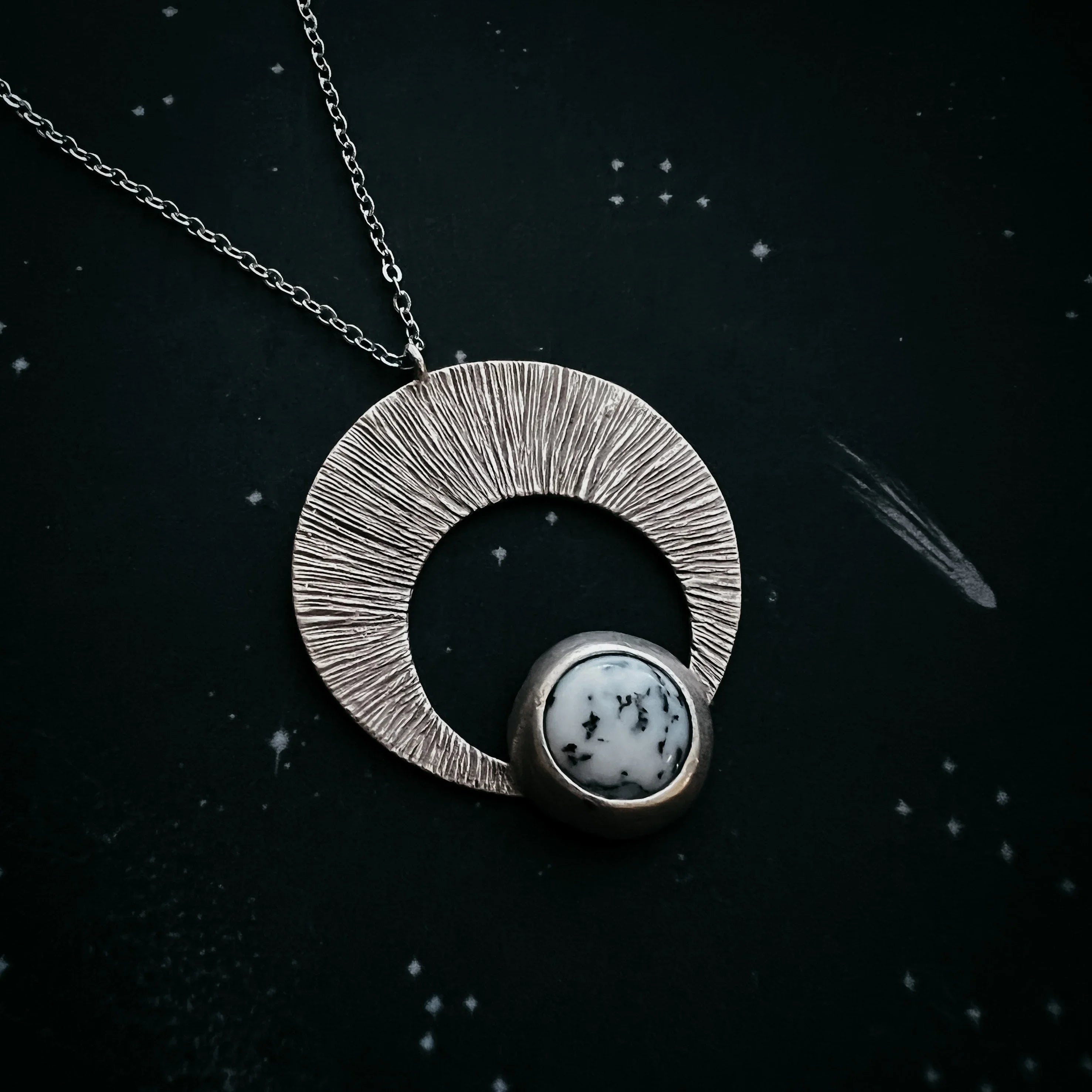 Cosmic-inspired silver pendant necklace with round white stone, artisan jewelry at Qu!rk Boutique