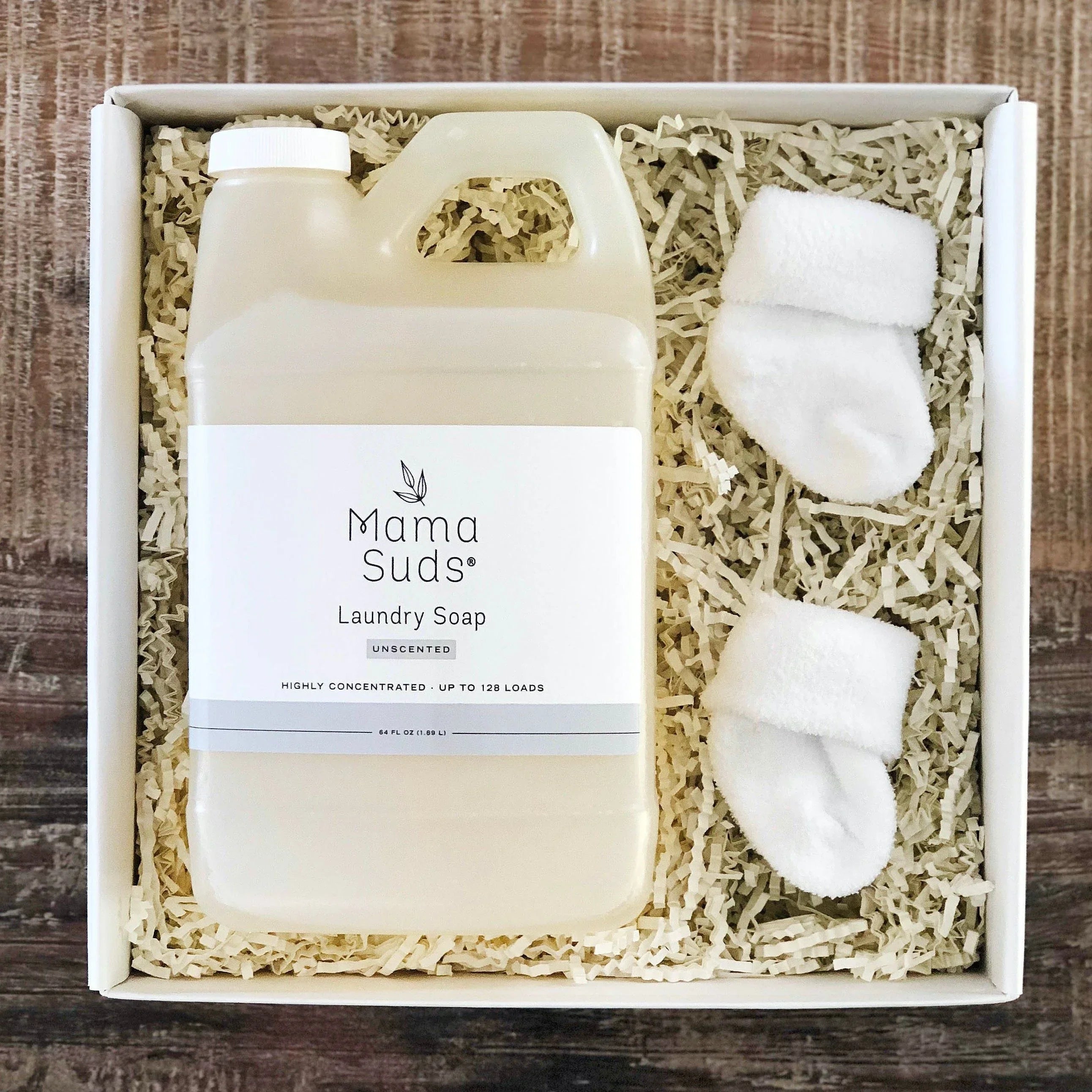 Mama Suds laundry soap gift box with baby socks on wood, Qu!rk Boutique eco-friendly gift
