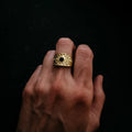 Hand wearing gold celestial ring with black stone, Qu!rk Boutique artist-designed jewelry