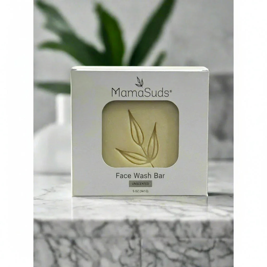 MamaSuds unscented face wash bar in eco-friendly packaging on marble countertop