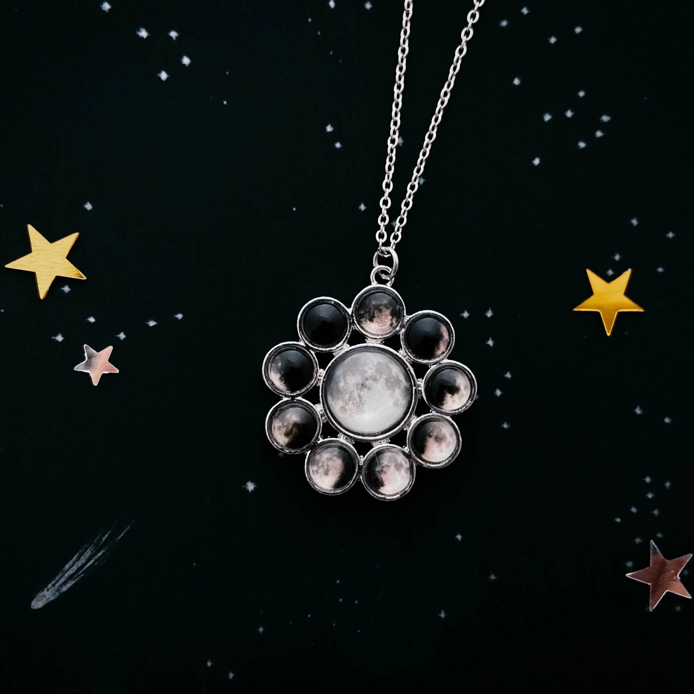 Cosmic-inspired moon phase necklace on starry black background, Qu!rk Boutique jewelry gift