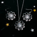 Moon phase necklace and earrings set on starry black background, Qu!rk Boutique cosmic jewelry