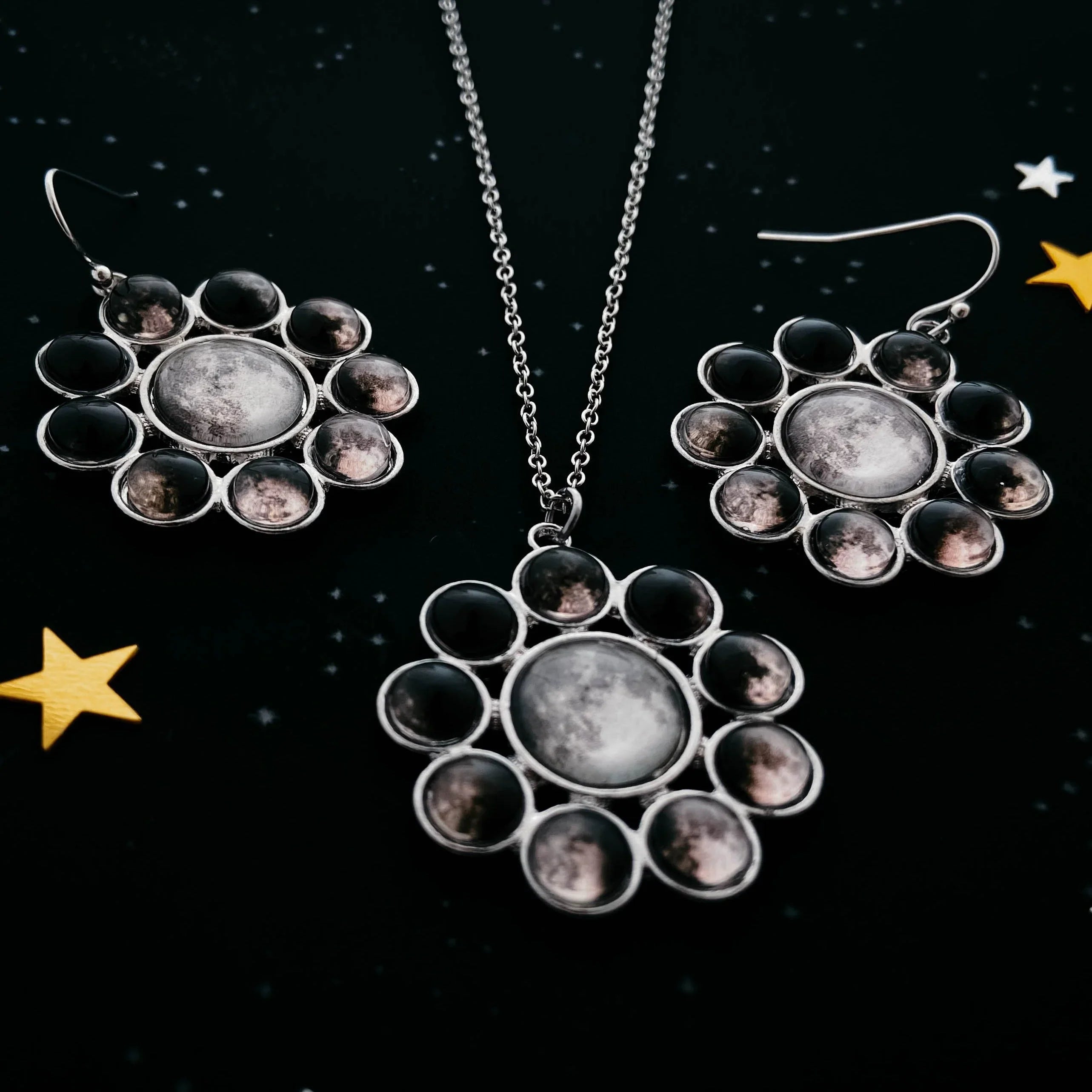 Celestial moon phase necklace and earrings set on starry black background from Qu!rk Boutique.