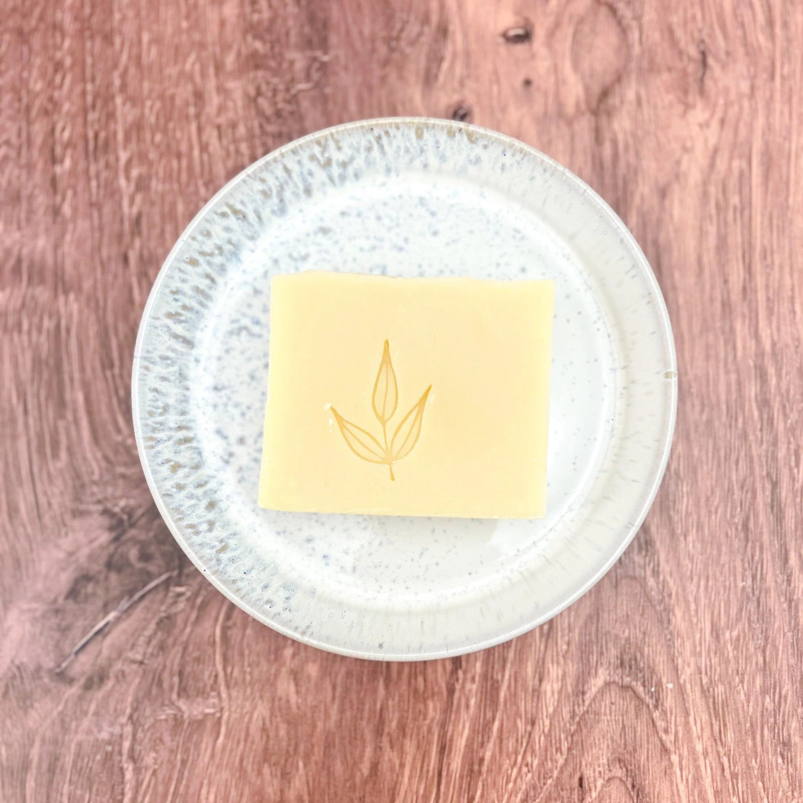 Handmade bar soap with leaf design on ceramic plate, Qu!rk Boutique eco-friendly gift