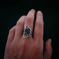 Hand wearing a unique artisan silver ring with moon and butterfly design, Qu!rk Boutique jewelry