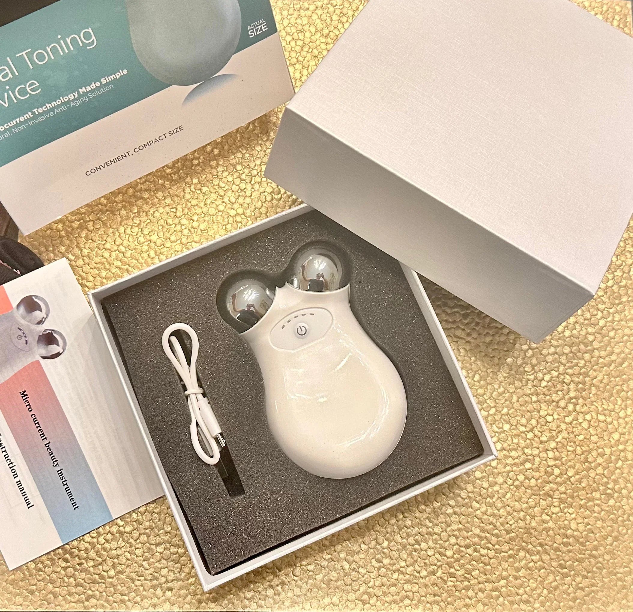 Facial toning device with USB cable in gift box at Qu!rk Boutique, woman-owned gift shop