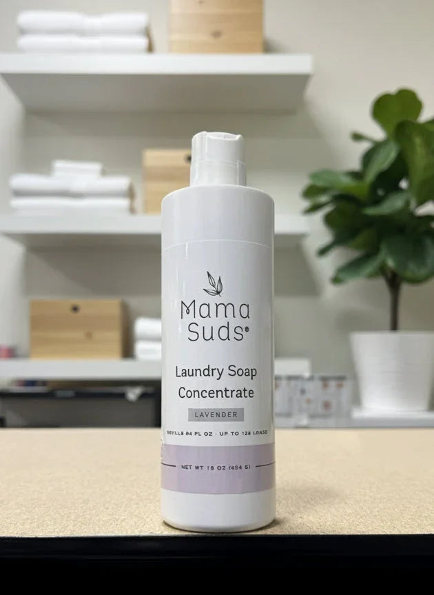 Mama Suds lavender laundry soap concentrate bottle on table in modern boutique shop setting